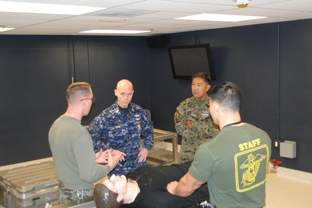 HM1 (FMF) Wilder and Sgt Welsh, demonstrate the training aids to FORMC Boss and CMC Patawaran. The FORMC made a vistit to FMTBW December 12, 2011.