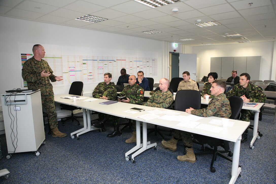 Major Tim Robertson, a Marine Forces Europe planning and logistics officer, discusses plans for the upcoming Black Sea Rotational Force in March of 2012, with members of the Romanian and Bulgarian militaries and fellow Marines, aboard United States Army Garrison Stuttgart's Panzer Kaserne, Dec. 14.  MFE hosted the final planning conference for BSRF-12, a 6-month training exercise, involving 19 nations, with 71 training events planned throughout the Black Sea, Balkan, and Caucasus regions.  ::r::::n::::r::::n::