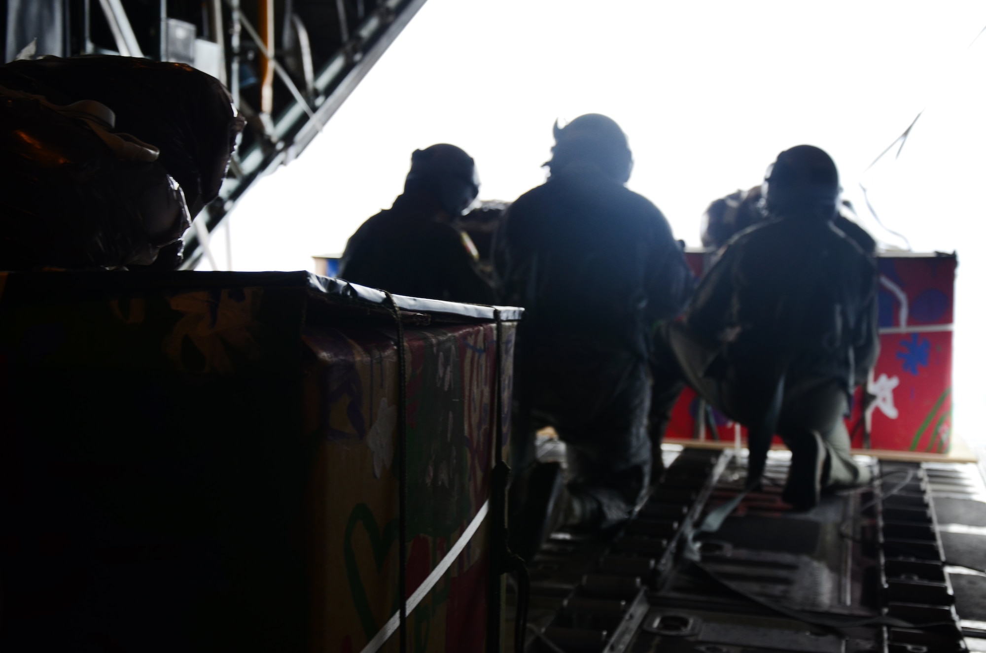 Over Fais Island, Micronesia - Aircrew from the 374th Airlift Wing prepare to push a pallet of medical supplies to the island Fais to treat an outbreak of dengue fever.  The island of Fais is located within the Yap state of the Micronesian Islands, and is one of the more than 50 islands that will receive care packages this holiday season as part of Operation Christmas Drop.  (U.S. Air Force photo/Senior Airman Veronica McMahon)