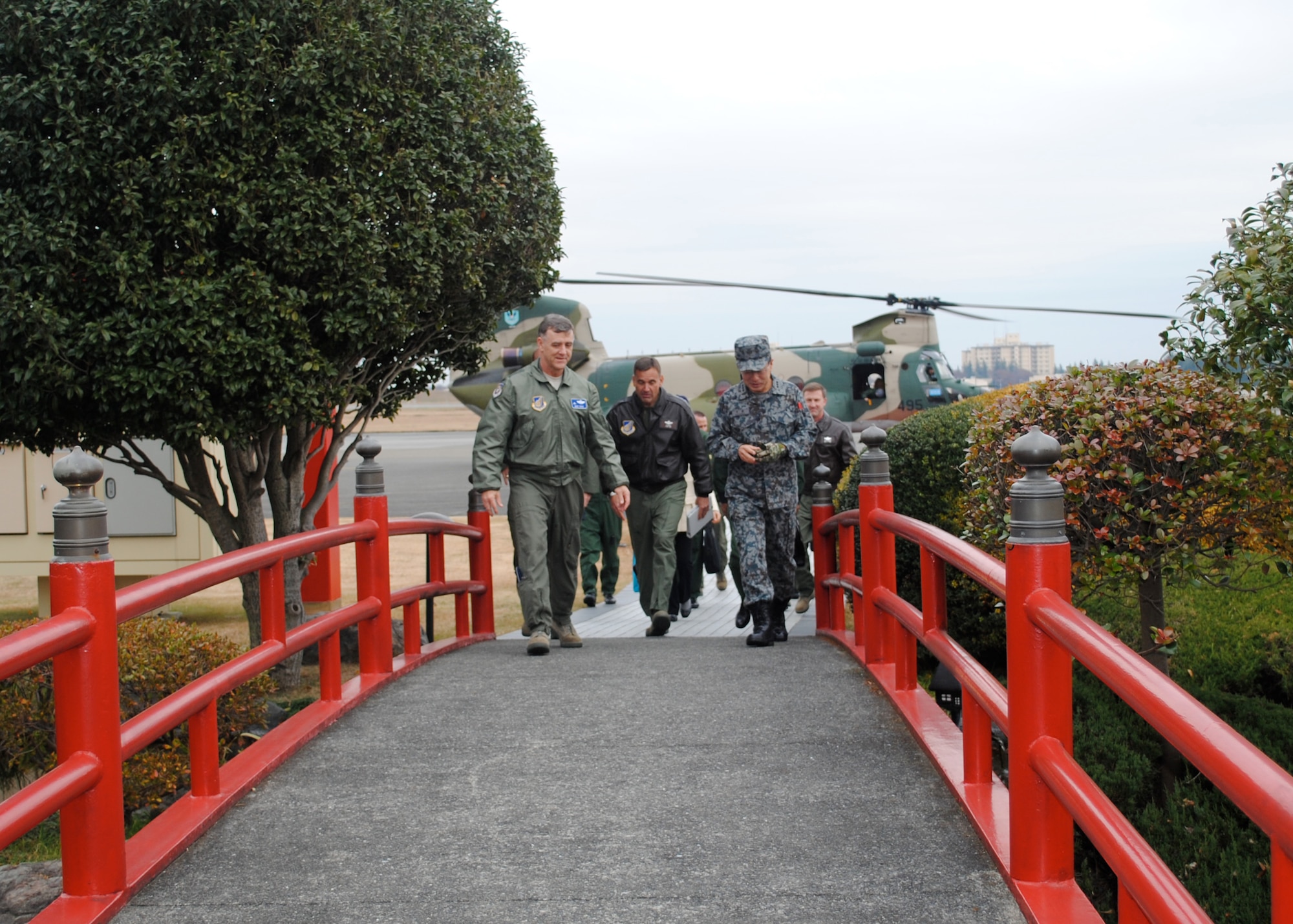 YOKOTA AIR BASE, Japan -- Lt. Gen. Burton Field, left, US Forces Japan and 5th Air Force Commander, leads Lt. Gen. Ted Kresge, center, 13th Air Force Commander, and Japan Air Self-Defense Force Lt. Gen. Haruhiko Kataoka, right, Air Defense Command Commander, to Headquarters USFJ here Dec. 14, 2011.  The generals met to discuss the US-Japan military alliance and the upcoming Keen Edge exercise scheduled for January 2012.  (U.S. Air Force photo/Capt. Will Powell)