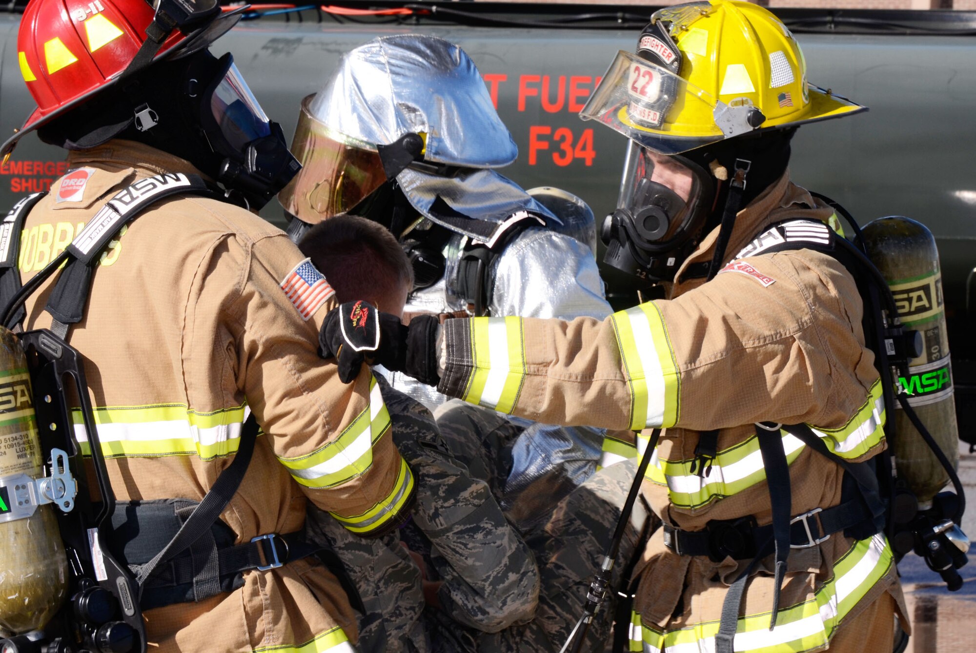 Members of the Dobbins Fire and Rescue Services removes a victim from danger at a simulated accident scene during a mass casualty exercise held here Dec. 13. (U.S. Air Force photo/Don Peek)