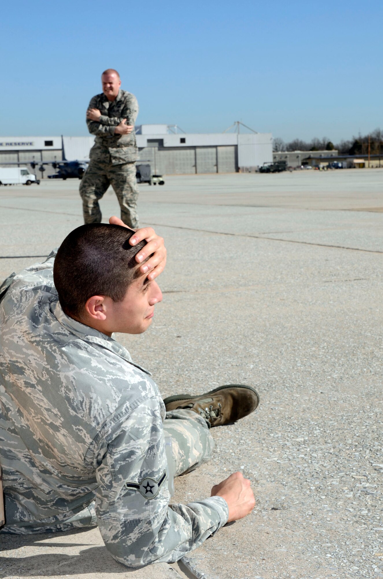 Airmen Ricardo Hernandez and Anthony Sigman of the 94th Maintenance Squadron posed as injured personnel during a mass casualty exercise held here Dec. 13. (U.S. Air Force photo/Don Peek)