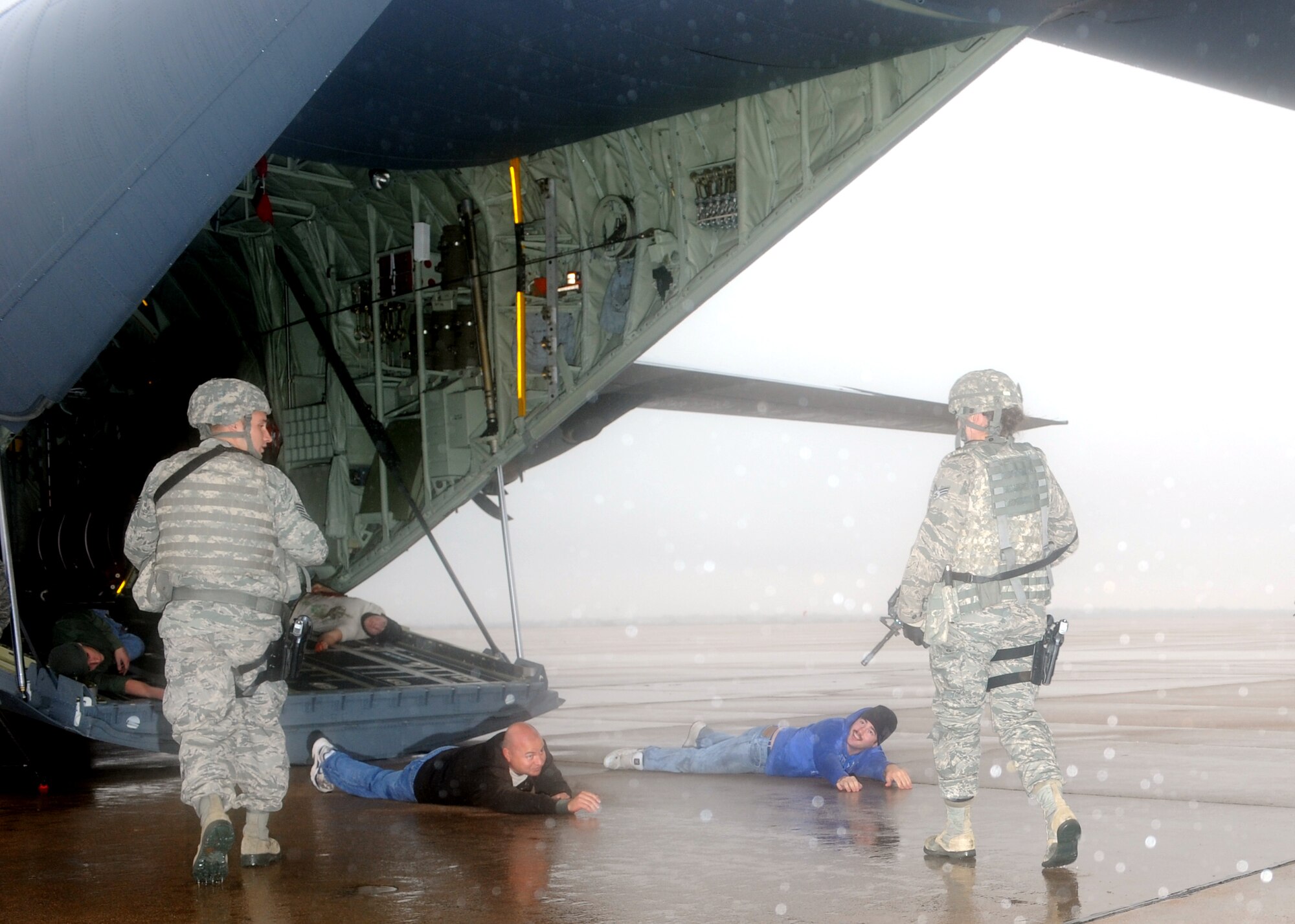 Airmen from the 7th Security Forces Squadron inspect a C-130 during an Emergency Management Exercise Dec. 13, 2011, at Dyess Air Force Base, Texas. The exercise tested response time to a terrorist hijacking scenario and consisted of more than 200 Dyess members. Exercises vary in scenarios and are conducted every two months keeping airmen prepared for real world situations. (U.S. Air Force photo by Airman 1st Class Jonathan Stefanko/ Released)
