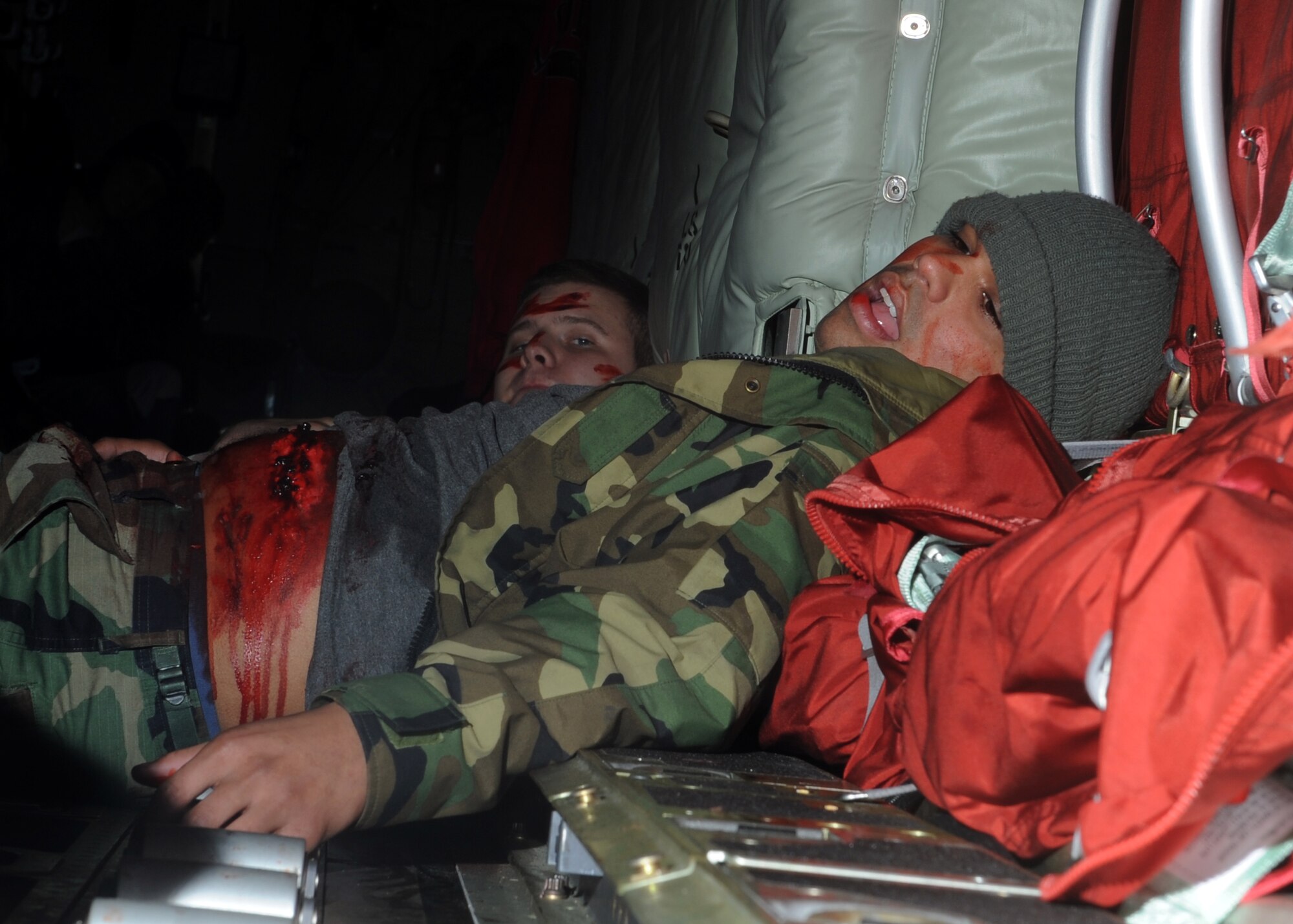 An airman playing as a moulage lays in the back of a C-130 during an Emergency Management Exercise Dec. 13, 2011, at Dyess Air Force Base, Texas. The exercise tested response time to a terrorist hijacking scenario and consisted of more than 200 Dyess members. Exercises vary in scenarios and are conducted every two months keeping airmen prepared for real world situations. (U.S. Air Force photo by Airman 1st Class Jonathan Stefanko/ Released)