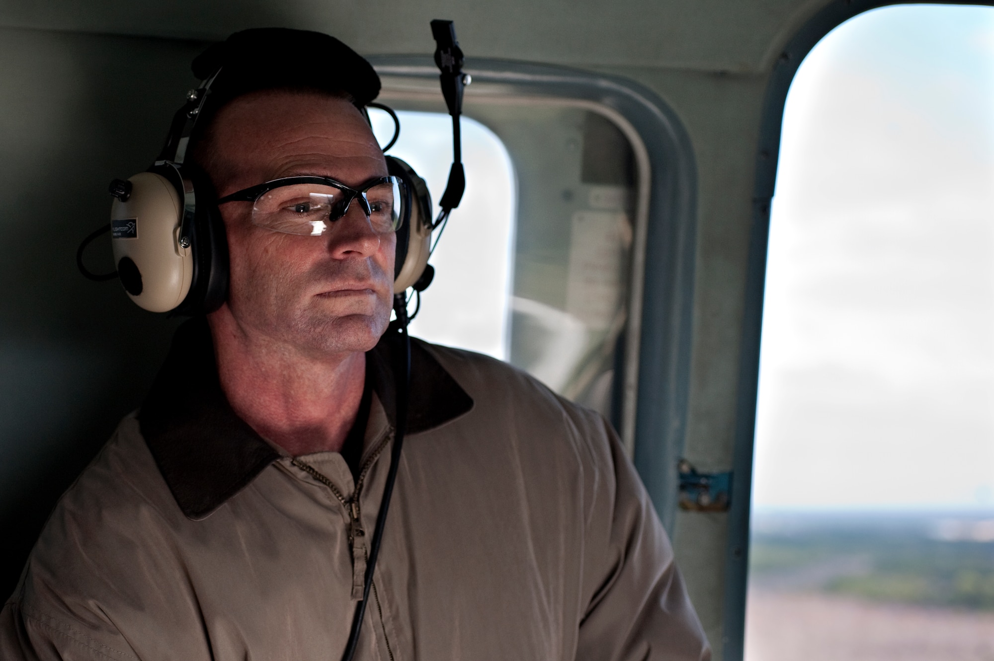 Dr. Brian Shonk, honorary commander of the 505th Training Squadron, looks out the door of an Mi-17 Hip during an honorary commander flight over Hurlburt Field, Fla., Dec. 13, 2011. Honorary commanders change annually and partake in events, luncheons and award ceremonies throughout the year as part of their honorary duties. (U.S. Air Force photo/Airman 1st Class Christopher Williams)(Released)