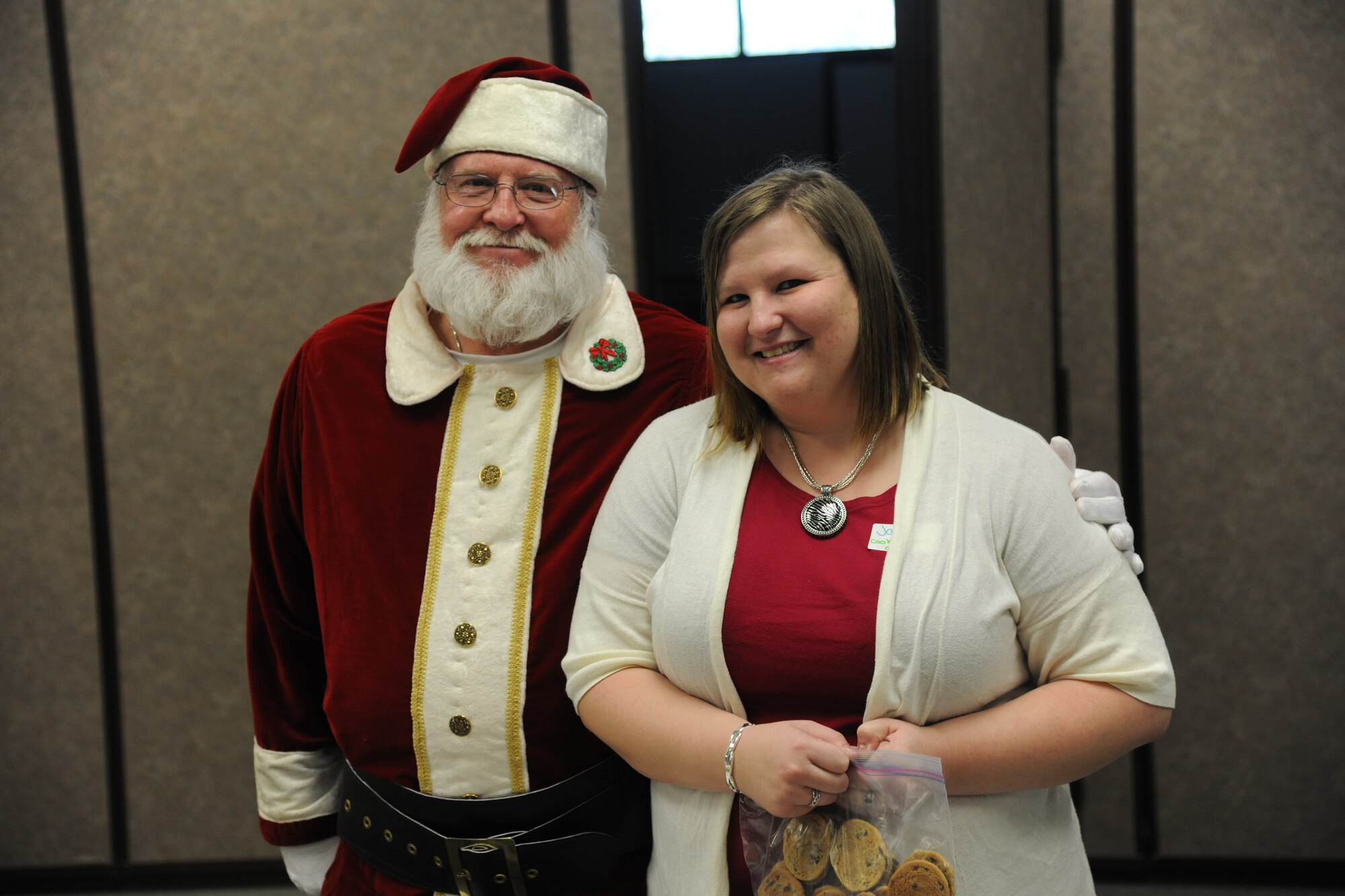Santa and Jacqui Winchell, cookie drive chairman, pose for a photo at the Base Chapel on Moody Air Force Base, Ga., Dec. 13, 2011. Santa took time out of his busy schedule to help sort and pack cookies for Airmen who live in the dormitories. (U.S. Air Force photo by Airman 1st Class Paul Francis/Released)
