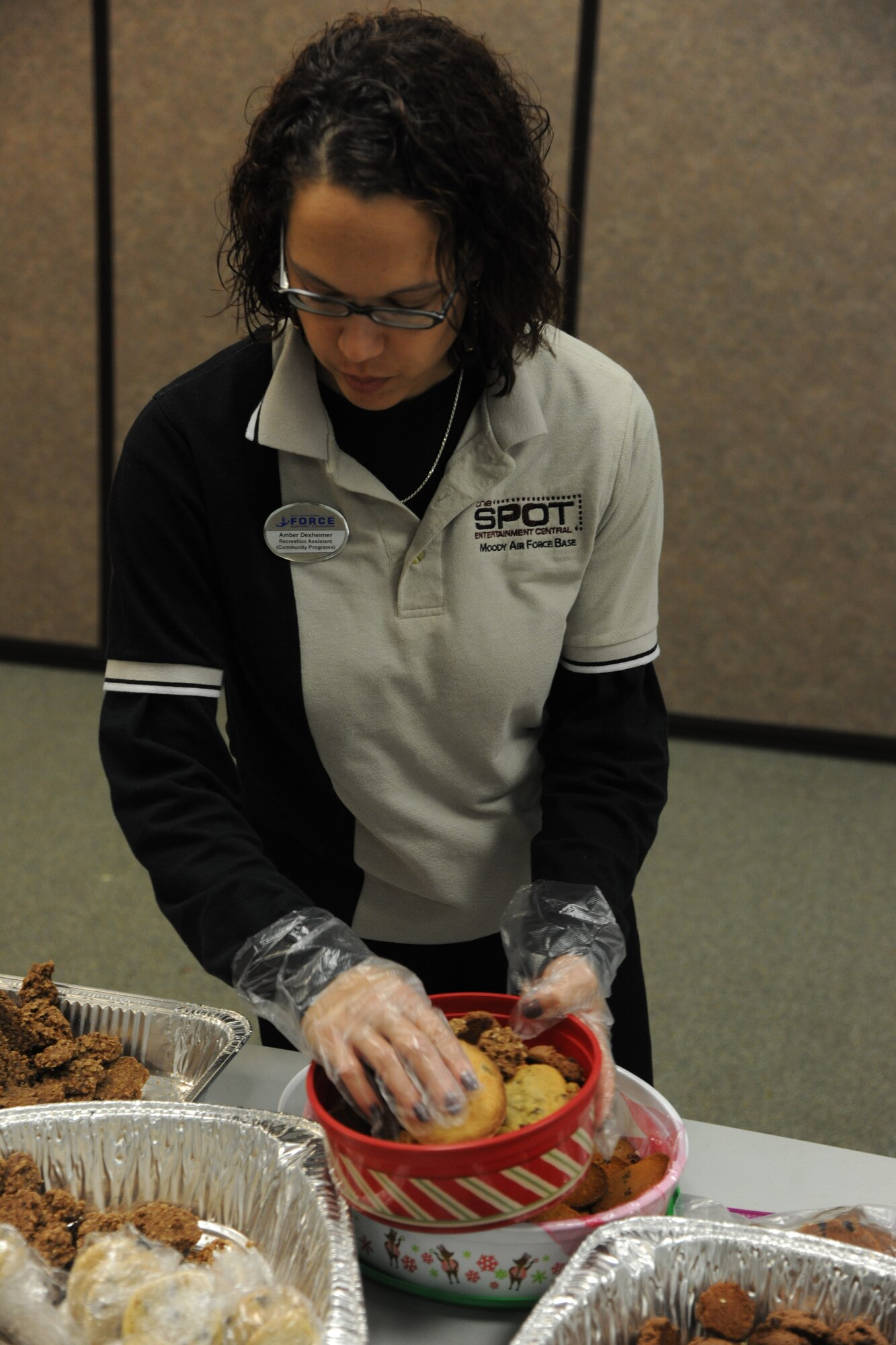 Amber Dexheimer, The Spot recreational assistant, sorts through cookies and places them in a container to be given to an Airman on Moody Air Force Base, Ga., Dec. 13, 2011. Each squadron receives a set amount of bags based on how many Airmen they have living in the dorms and how many are deployed downrange. (U.S. Air Force photo by Airman 1st Class Paul Francis/Released)
