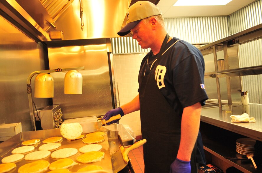 Chief Master Sgt. Scott Morris flips hotcakes for distribution at the Chief’s Group Pancake Breakfast at Seymour Johnson Air Force Base, N.C., Dec. 9, 2011. The Seymour Johnson Chief’s Group is comprised of all chief master sergeants on-base and exists to provide guidance and assistance to Airmen and professional organizations. Scott is from the exercise planning flight and hails from Grand Haven, Mich. (U.S. Air Force photo by Senior Airman Marissa Tucker)