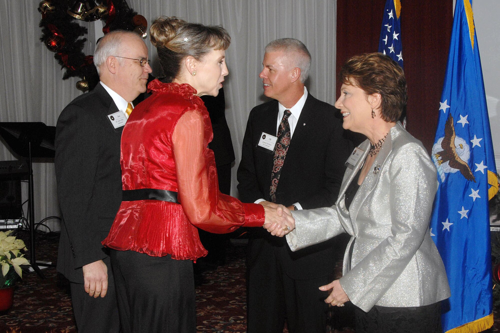HANSCOM AIR FORCE BASE, Mass. – Lt. Gen. CR Davis, Electronic Systems Center commander, and his wife, Susan (right), greet Jim Shaw, former 851st Electronic Systems Group commander (left), and his wife, Leslie, to the Commander’s Holiday Reception at the Minuteman Commons Dec. 10. The event was a chance for the local community to enjoy food, entertainment and welcome the new commander to Hanscom. (U.S. Air Force photo by Linda LaBonte Britt) 