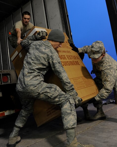 MINOT AIR FORCE BASE, N.D. -- 705th Munitions Squadron missile maintenance team members, unload a refrigerator from a truck here Dec. 12. This is part of Operation Homefront, a charitable initiative, headed by the Home Depot Foundation, in coordination with Minot AFB’s Operation Warmheart and General Electric, to donate135 appliances to Team Minot Airmen and their families affected by the historic Souris River flood. (U.S. Air Force photo/Airman 1st Class Stephanie Ashley)