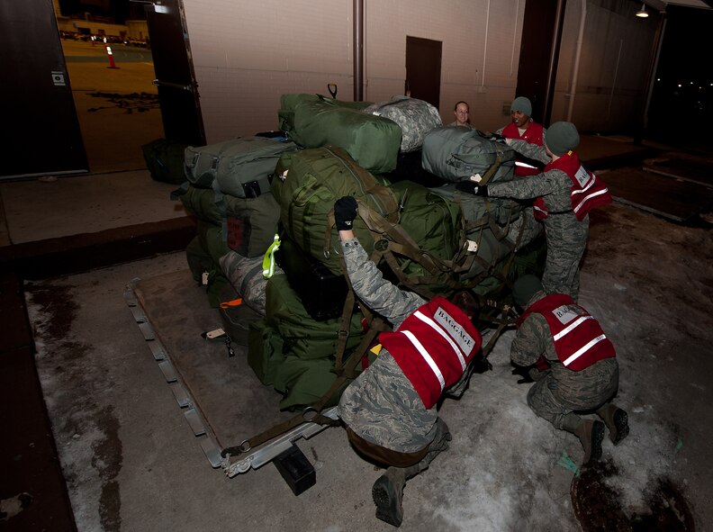 Airmen of the 28th Medical Group secure duffle bags on a pallet during an Operational Readiness Exercise on Ellsworth Air Force Base, S.D., Dec. 8, 2011. The Airmen received training on how to properly build pallets. (U.S. Air Force photo by Airman 1st Class Kate Thornton/Released) 