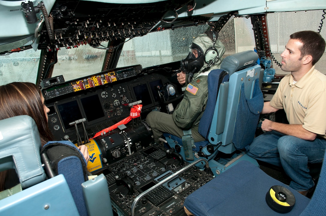 Erin Kennedy and Steve Leadore, Joint Service Aircrew Mask - Fixed Wing (JSAM-FW) research team members, get feedback on the mask from 167th Airlift Squadron pilot, Major Jeff Musser. A Department of Defense research team working on the development of a JSAM-FW conducted field assessments at the 167th Airlift Wing, West Virginia Air National Guard unit in Martinsburg, WV,  December 7, 2011. The team had aircrew in each of the flying positions don the mask and accompanying gear and perform their duties on a C-5 aircraft. (Air National Guard photo by Master Sgt. Emily Beightol-Deyerle)