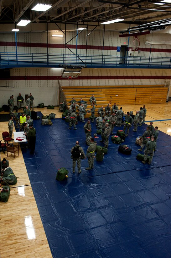 Ellsworth Airmen meet in the Bellamy Fitness Center to begin the deployment processing portion of an Operational Readiness Exercise on Ellsworth Air Force Base, S.D., Dec. 6, 2011. Airmen gathered and awaited transportation to the Pride Hangar where they were quickly out-processed for the simulated mass deployment. (U.S. Air Force photo by Airman 1st Class Kate Thornton/Released)