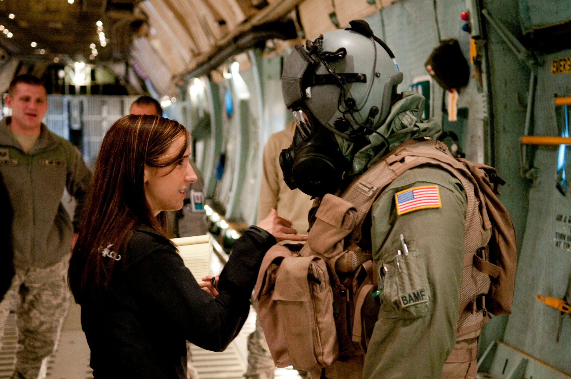Erin Kennedy, a chemical engineer for the Army and the Joint Service Aircrew Mask-Fixed Wing (JSAM-FW) test and evaluation lead, gets feedback from Technical Sgt. Michael Lindamood during a field evaluation of the gear. A Department of Defense research team working on the development of a JSAM conducted field assessments at the 167th Airlift Wing, West Virginia Air National Guard unit in Martinsburg, WV,  December 7, 2011. The team had aircrew in each of the flying positions don the mask and accompanying gear and perform their duties on a C-5 aircraft. (Air National Guard photo by Master Sgt. Emily Beightol-Deyerle)