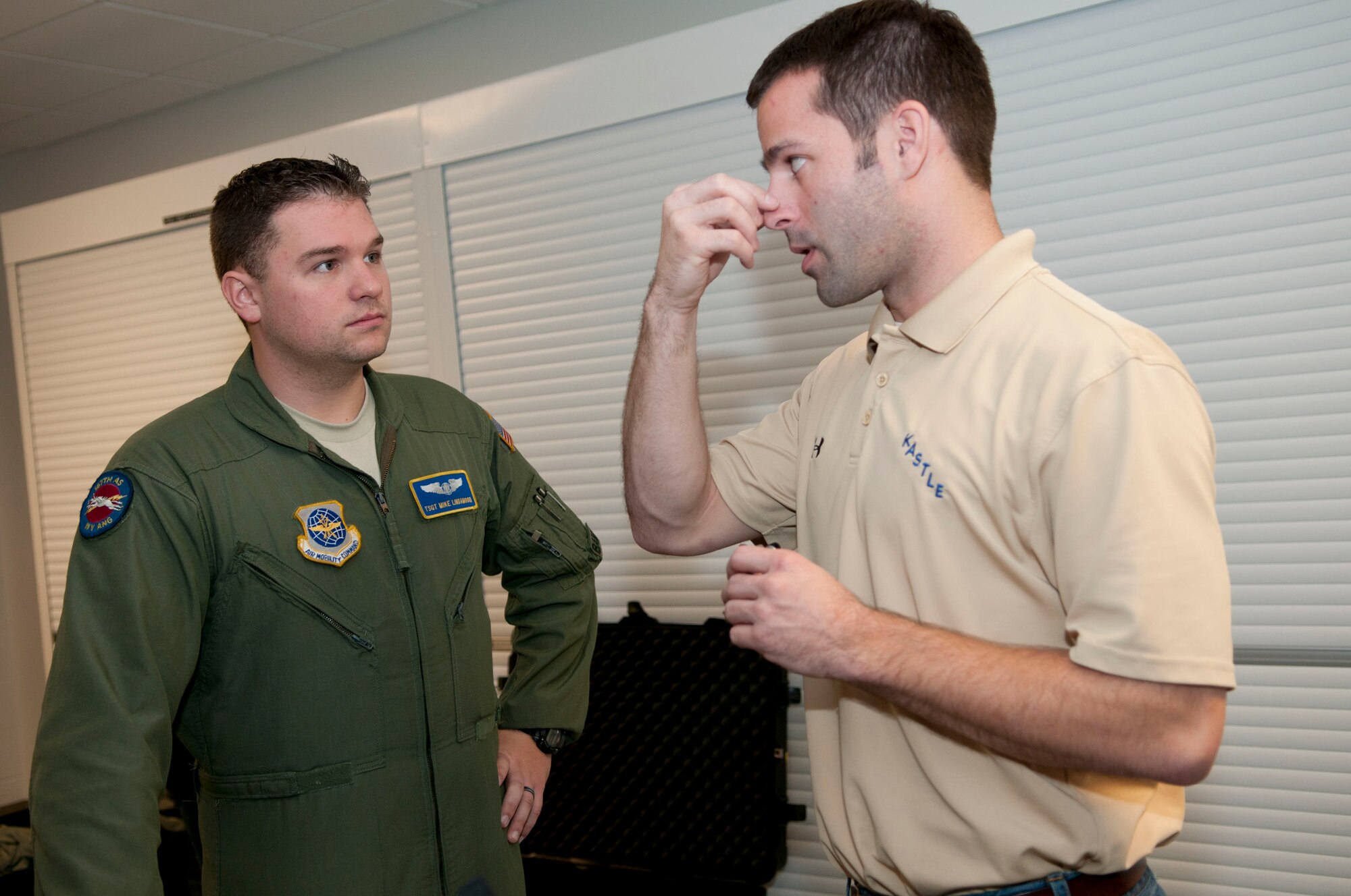 Steve Leadore, an equipment technician for the joint service aircrew mask - fixed wing (JSAM-FW) research team, explains the nosepiece for a mask to Technical Sgt. Michael Lindamood, a loadmaster for the 167th Airlift Squadron. A Department of Defense research team working on the development of a joint service aircrew mask conducted field assessments at the 167th Airlift Wing, West Virginia Air National Guard unit in Martinsburg, WV,  December 7, 2011. The team had aircrew in each of the flying positions don the mask and accompanying gear and perform their duties on a C-5 aircraft. (Air National Guard photo by Master Sgt. Emily Beightol-Deyerle)