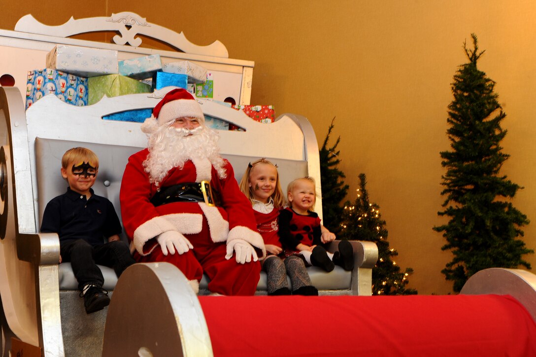 Dylan, 5, Grace, 8, and Emily, 1, have their picture taken with Santa Claus during the breakfast with Santa event at the Dakota’s Club on Ellsworth Air Force Base, S.D., Dec. 3, 2011. Airmen and their families enjoyed arts and crafts, face painting and pictures while receiving a gift from Santa Claus. (U.S. Air Force photo by Airman 1st Class Zachary Hada/Released)