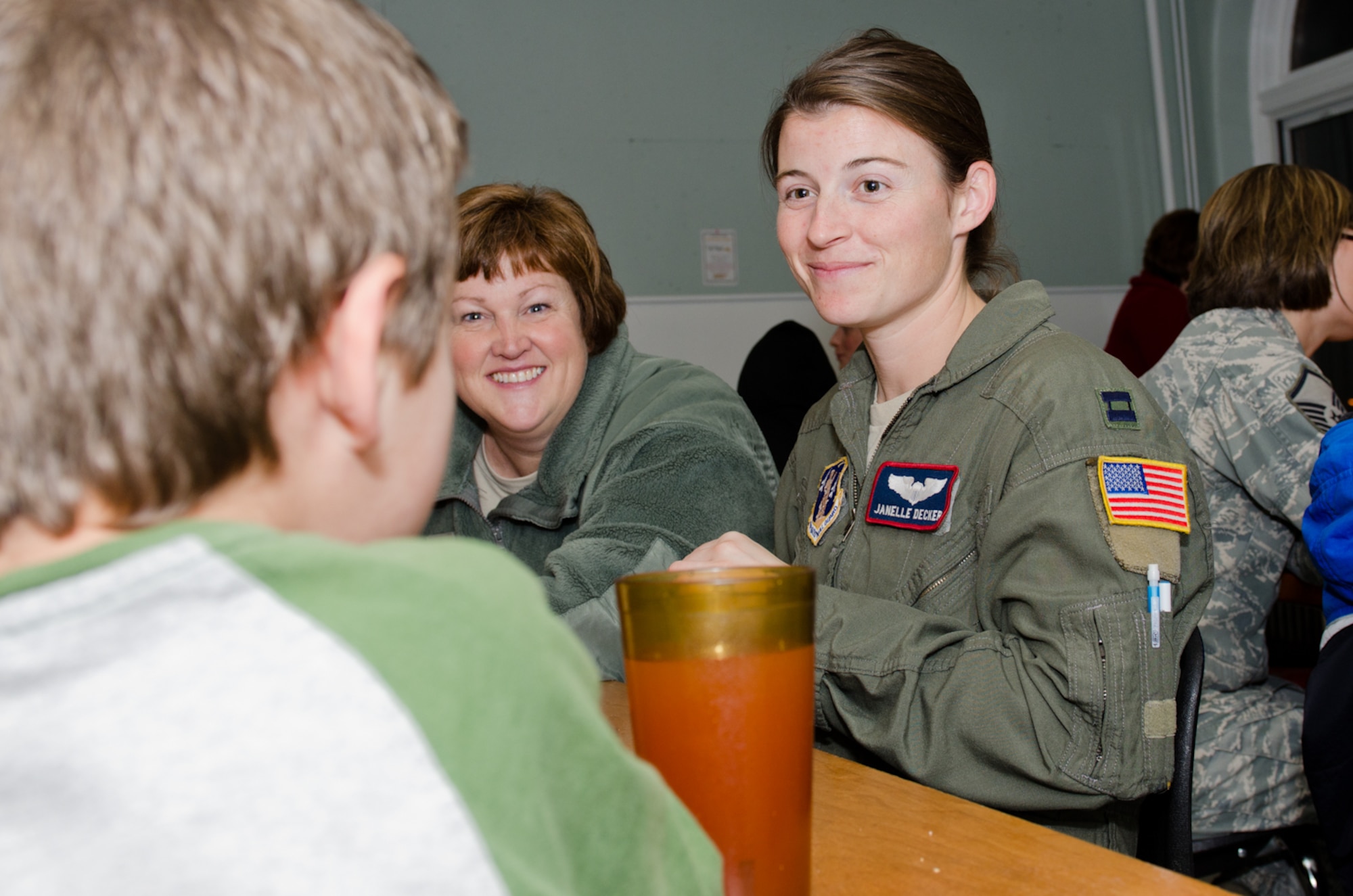 Capt. Janelle Decker (right), 180th Airlift Squadron, and Lt. Col. Kimberly Daniel, 139th Operations Group, talk with a kid from the Noyes Home for Children in St. Joseph, Mo., Dec. 13, 2011. Guardmembers of the 139th Airlift Wing teamed up with local businesses to donate Christmas gifts for the Noyes Home. (Missouri Air National Guard photo by Staff Sgt. Michael Crane)