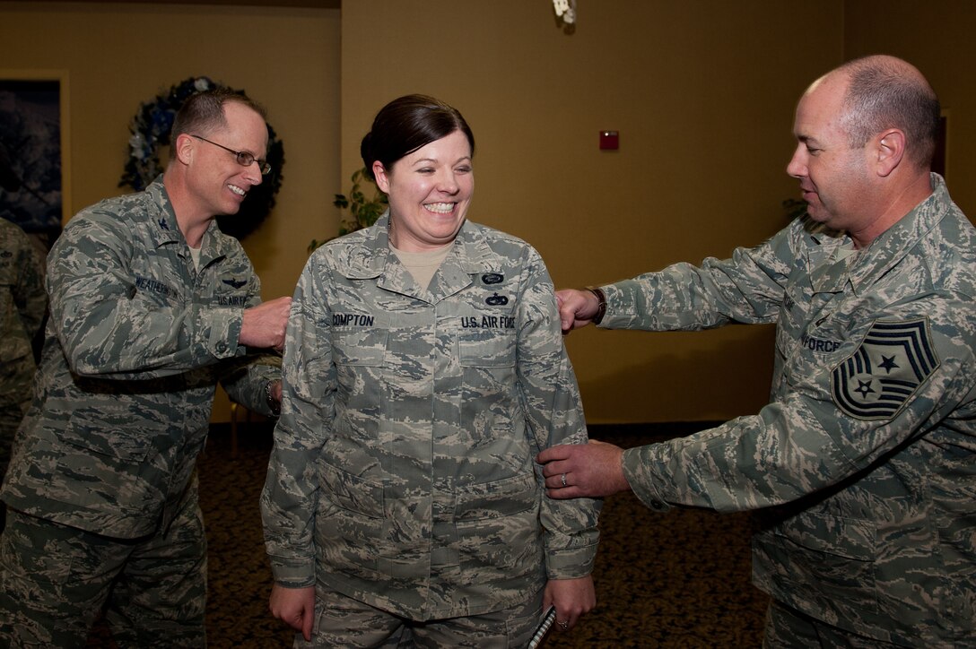 Col. Mark Weatherington, 28th Bomb Wing commander and Chief Master Sgt. Brian Lavoie, 28th BW command chief, promote Staff Sgt. Candice Compton, 28th BW Equal Opportunity adviser, to the rank of technical sergeant under the Stripes for Exceptional Performers program at the Dakota’s Club on Ellsworth Air Force Base, S.D., Dec. 13, 2011. The STEP program is a highly-visible promotion recognition program used by commanders to recognize the outstanding contributions and accomplishments of senior airmen, staff sergeants and technical sergeants. (U.S. Air Force photo by Airman 1st Class Kate Thornton/Released)