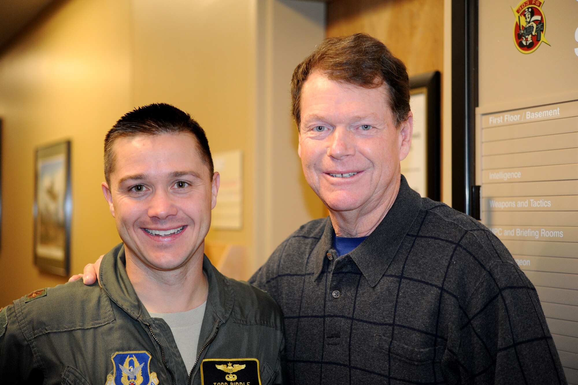 Maj. Todd Riddle, 303rd Fighter Squadron A-10 Thunderbolt II pilot, assists professional golfer Tom Watson in the A-10 simulator during a tour, Dec. 14, 2011. Watson, who has won eight major golf championships and headed the PGA Tour money list five times, was the No. 1 ranking golfer in the world from 1978-1982. Watson, who is a Kansas City, Mo. native, toured the wing with some 442nd Fighter Wing retirees. The 442nd FW is an Air Force Reserve unit at Whiteman Air Force Base, Mo. 