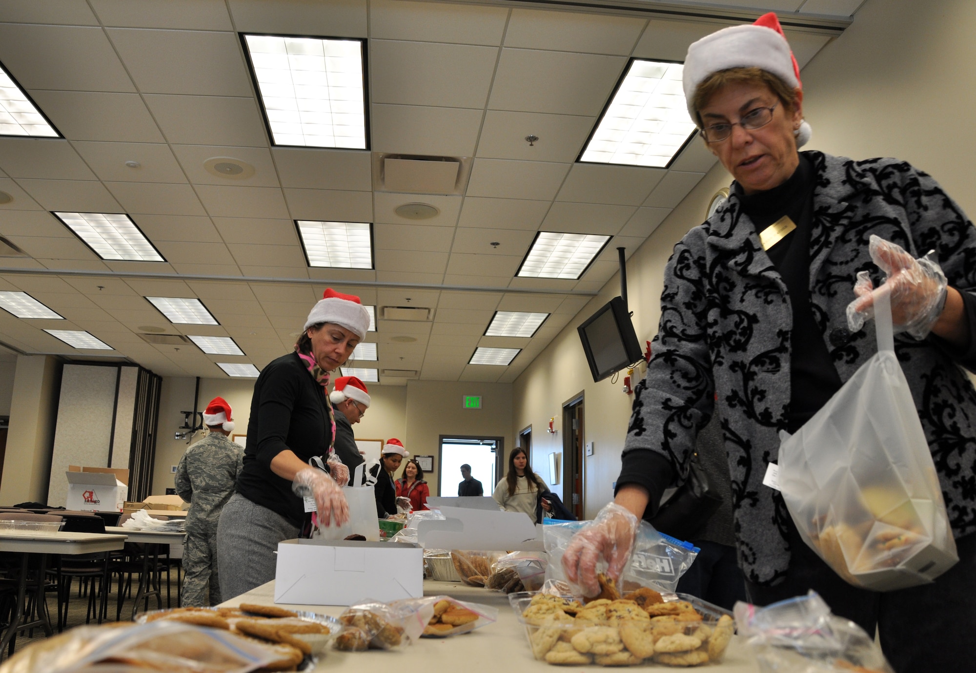 BUCKLEY AIR FORCE BASE, Colo. –- Volunteers from Buckley AFB bag cookies at the Chapel for this year’s Cookie Caper Dec. 8. The cookies were packaged into over 350 bags and distributed to Team Buckley members. (U.S. Air Force photo by Senior Airman Elisa Labbe)