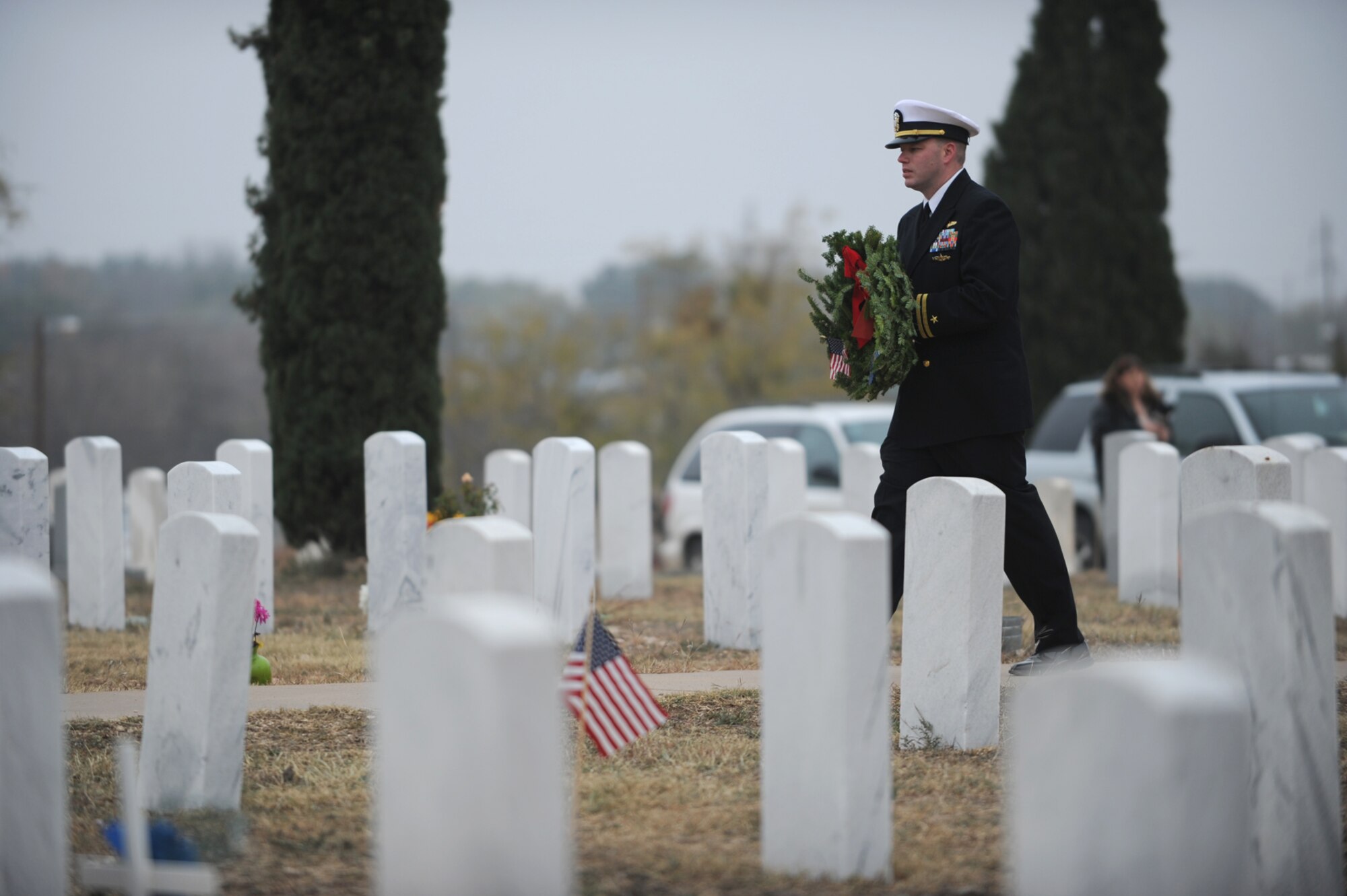 SAN ANGELO, Texas -- Navy Lt. Lonnie Griffith, Center for Information Dominance Detachment Commander, carries a wreath representing the U.S. Navy during the Civil Air Patrol's annual Wreaths Across America event at Belvedere Memorial Park Cemetery Dec. 10. The ceremony here as well as other ceremonies across the nation remembers our fallen heroes, honors those who serve and teaches our children about the sacrifices made by veterans and their families to preserve our freedoms. (U.S. Air Force photo/Staff Sgt. Laura R. McFarlane)