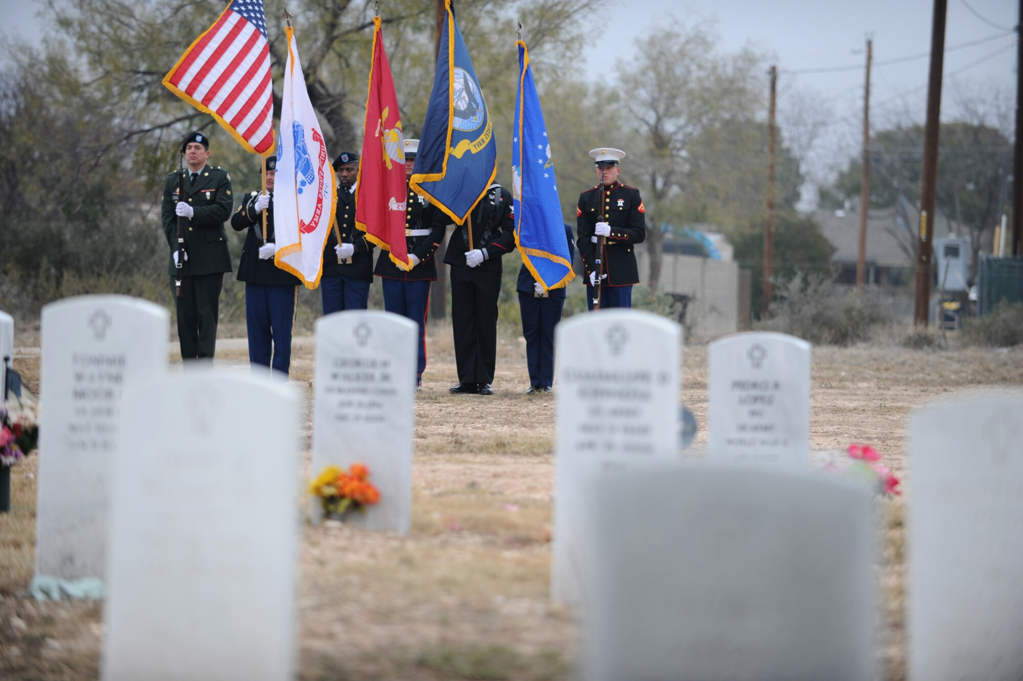 SAN ANGELO, Texas -- Goodfellow Air Force Base’s Joint Service Color Guard present the colors during the Civil Air Patrol's annual Wreaths Across America event at Belvedere Memorial Park Cemetery Dec. 10. The event honored the courage and sacrifice of veterans of the Armed Forces and the Merchant Marine. (U.S. Air Force photo/Staff Sgt. Laura R. McFarlane)