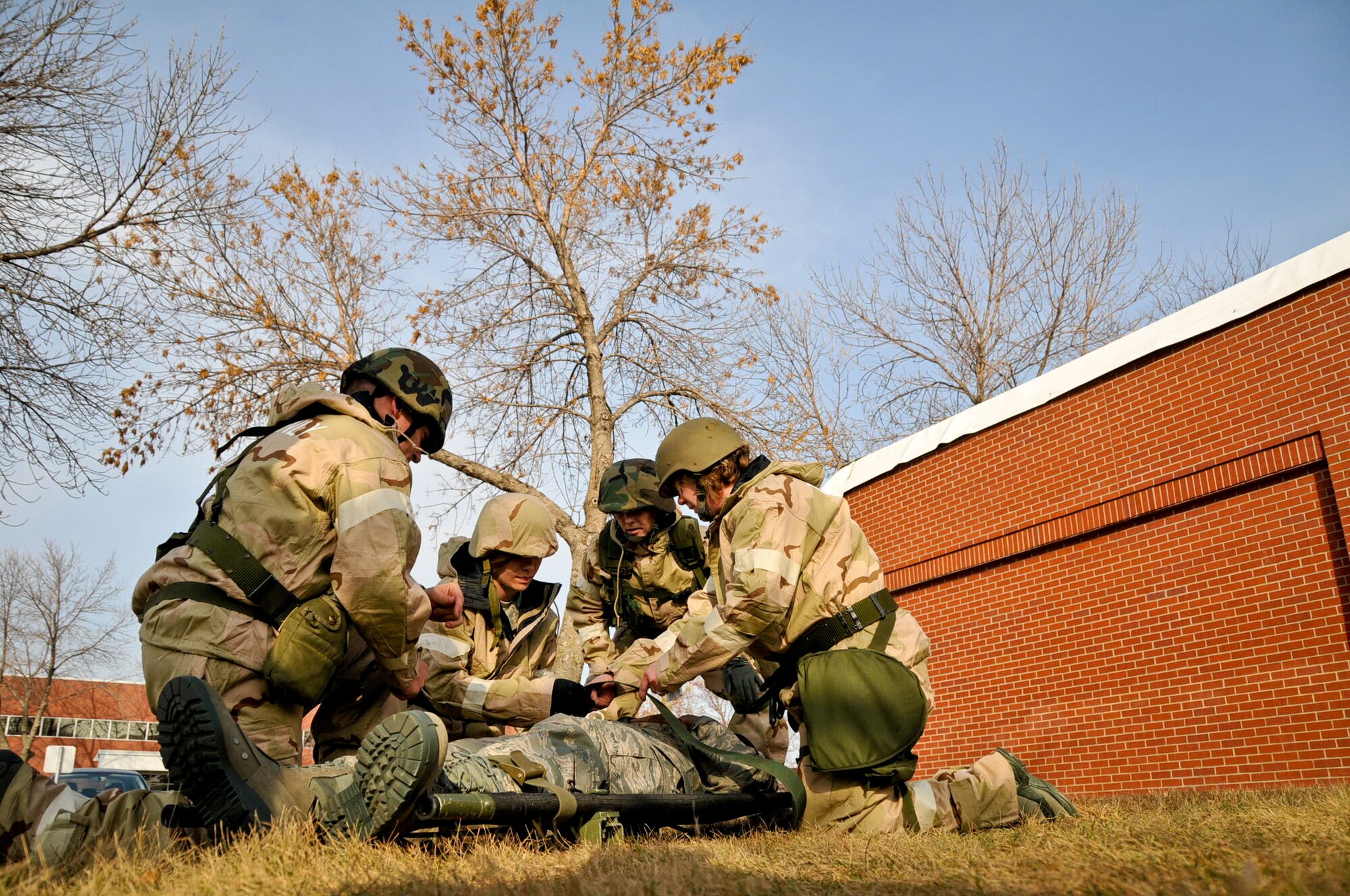 After administering self aid and buddy care, members of the 934th Airlift Wing prepare to transport a “wounded” Airman to a secure area after a simulated chemical attack. During the November Unit Training Assembly, Citizen Airmen of the 934 AW participated in a Readiness Assistance Visit I to prepare for the wing’s upcoming Operational Readiness Inspection.  (Air Force Photo/TSgt. Jim Loehr)