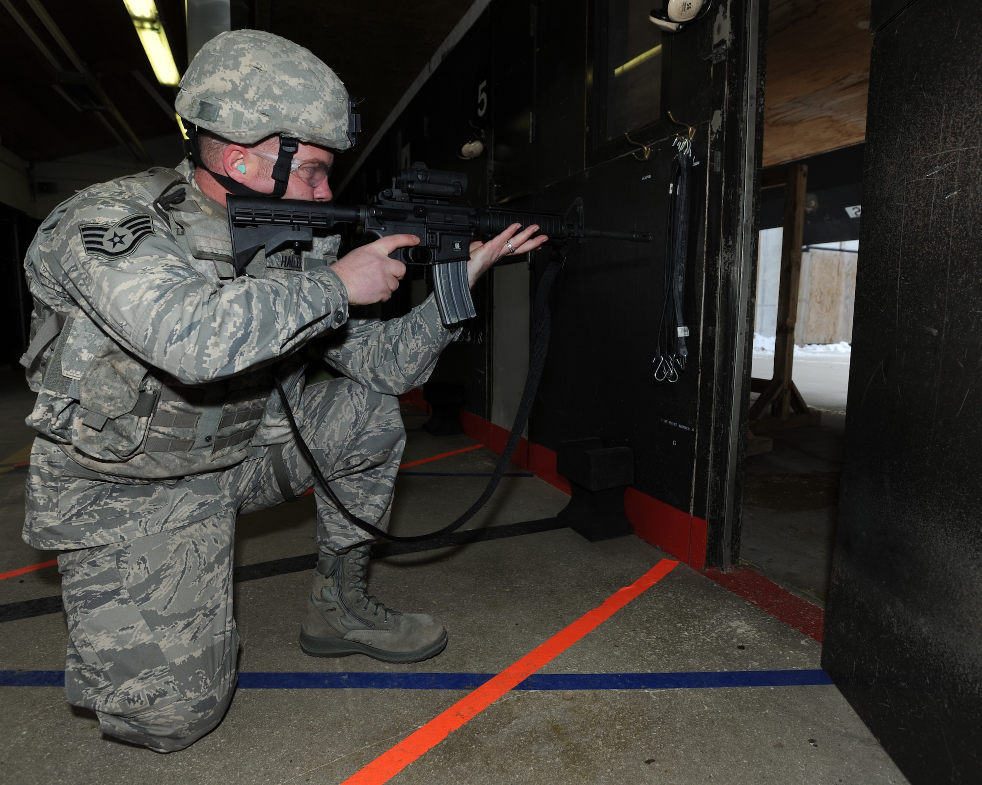 MINOT AIR FORCE BASE, N.D. -- Staff Sgt. Joseph Haller, 5th Security Forces Squadron combat arms training and maintenance instructor, looks down the sight of his M-4 rifle at the shooting range here Dec. 7. Haller was recently awarded the Airman’s Medal for the heroic and selfless act he performed back in the fall of 2008. (U.S. Air Force photo/Airman 1st Class Stephanie Ashley)