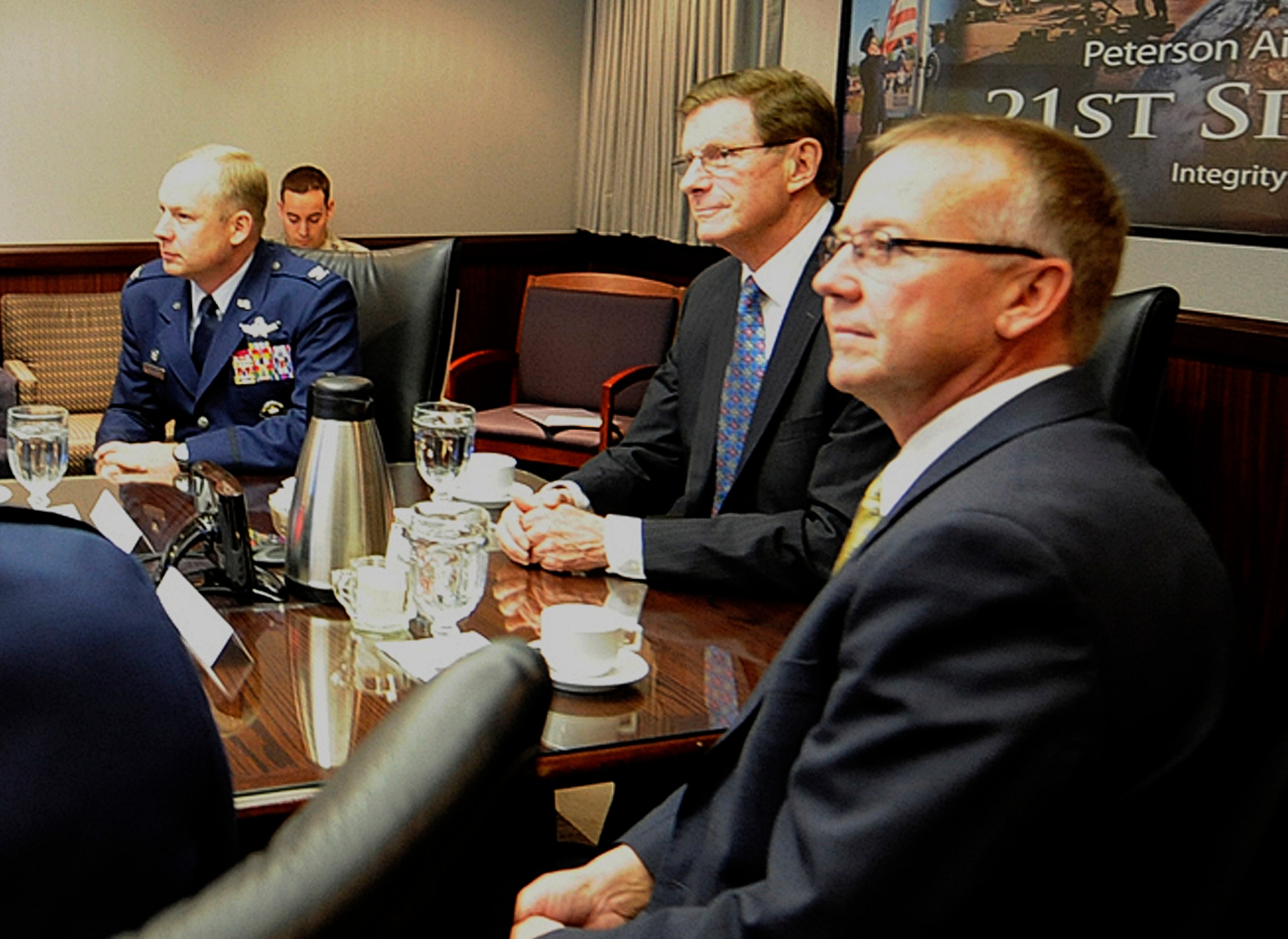 PETERSON AIR FORCE BASE, Colo. – Colorado Spring’s mayor, Steve Bach, (center), and his chief of staff Steve Cox (right), view the 21st Space Wing mission brief with Col. Chris Crawford (left), 21st Space Wing commander, Dec. 13, 2011, in the wing headquarters building. This was Bach’s first visit to the wing since being elected under a new Colorado Spring’s mayoral system May 17, granting wider executive powers and administrative authority. During his visit, Bach learned more about the 21st SW’s global missile warning and space control missions, future growth plans and the wing’s mutual aid agreement as first responders to fires and emergencies at the city airport. (U.S. Air Force photo/Rob Bussard)