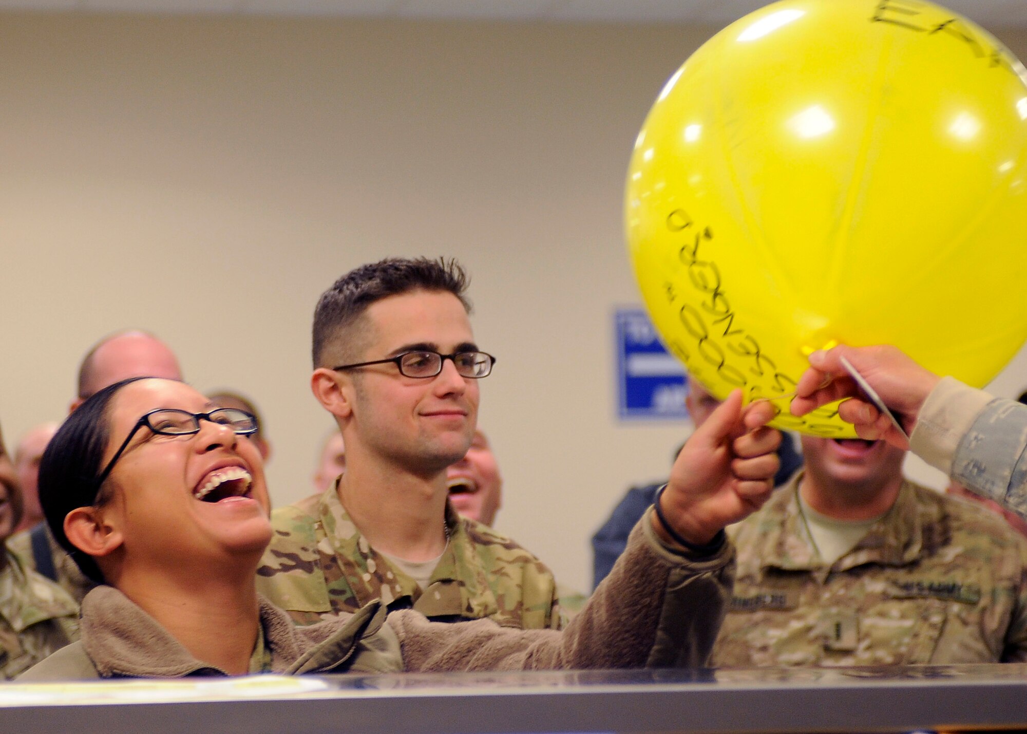 BAGRAM AIRFIELD, Afghanistan - Army Pvt. Griselda Hernandez is the 500,000th passenger here at the passenger terminal Dec. 9, 2011. This year, the Bagram Passenger Terminal exceeded last year's numbers by 4,850 passengers.
The passenger services division of the 455th Expeditionary Aerial Port Squadron held a small celebration to commemorate the landmark and exceeding the squadron’s previous year’s total by nearly 5,000 passengers.  But, the year was not over yet.  Capt. Franklin Rinaca, 455 EAPS officer in charge, predicted the year-end numbers to total above 535,000.  This mission supported the fight by ensuring troops enter and exit the region efficiently and expeditiously.  “We are the busiest aerial port in DoD,” said Capt. Rinaca.  “This is in terms of missions, passengers, and cargo moved.”  The statistical data was captured using passenger manifests.  The 24-hour operation pushed out 109 missions a day, moving nearly 1,500 passengers.  The passenger services mission supports  all services to include coalition forces, DoD civilians, DoD contractors, military working dogs, detainees, and media.
 (U.S. Air Force photo/ Senior Airman Krista Rose)
