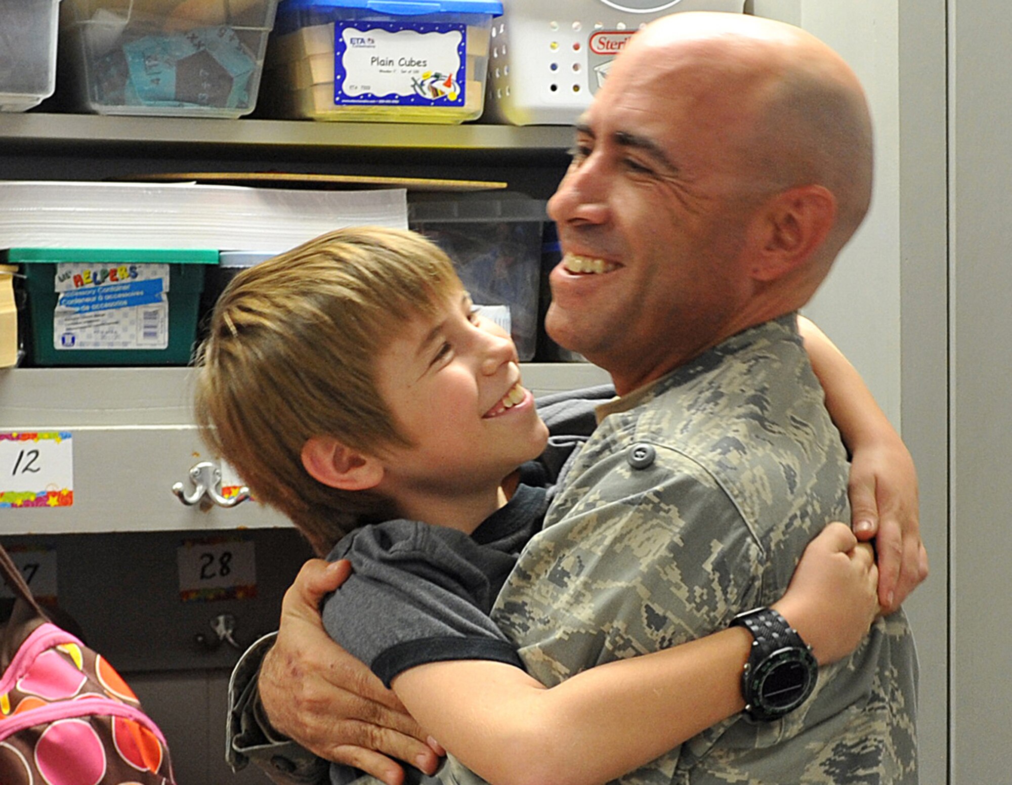 James wraps his arms around his dad, Capt. Nathan List, during a surprise welcome home Dec. 9 at Shirley Hills Elementary School in Warner Robins, Ga.  Captain List ended his six-month deployment to Al Asad Air Base, Iraq, three weeks early, and with the help of the school staffs was able to surprise his children in their classrooms. “It was a long road home,” said List. “Tuesday (Dec.  6) I was in Iraq and today I’m with my family. It’s a great feeling,” he said.  (U.S. Air Force photo/Tommie Horton)