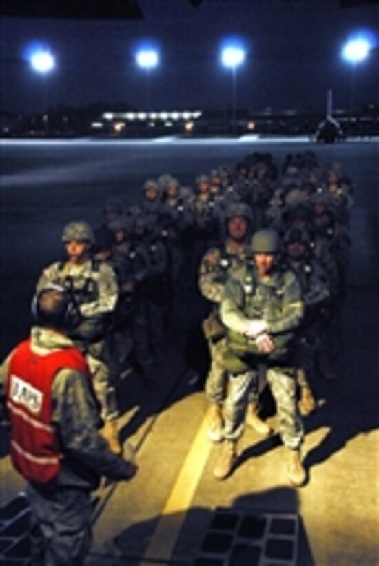 Paratroopers prepare to board their aircraft for the first jump of the day in support of the 14th Annual Operation Randy Oler Memorial Operation Toy Drop at Pope Army Air Field, N.C., on Dec. 10, 2011.  