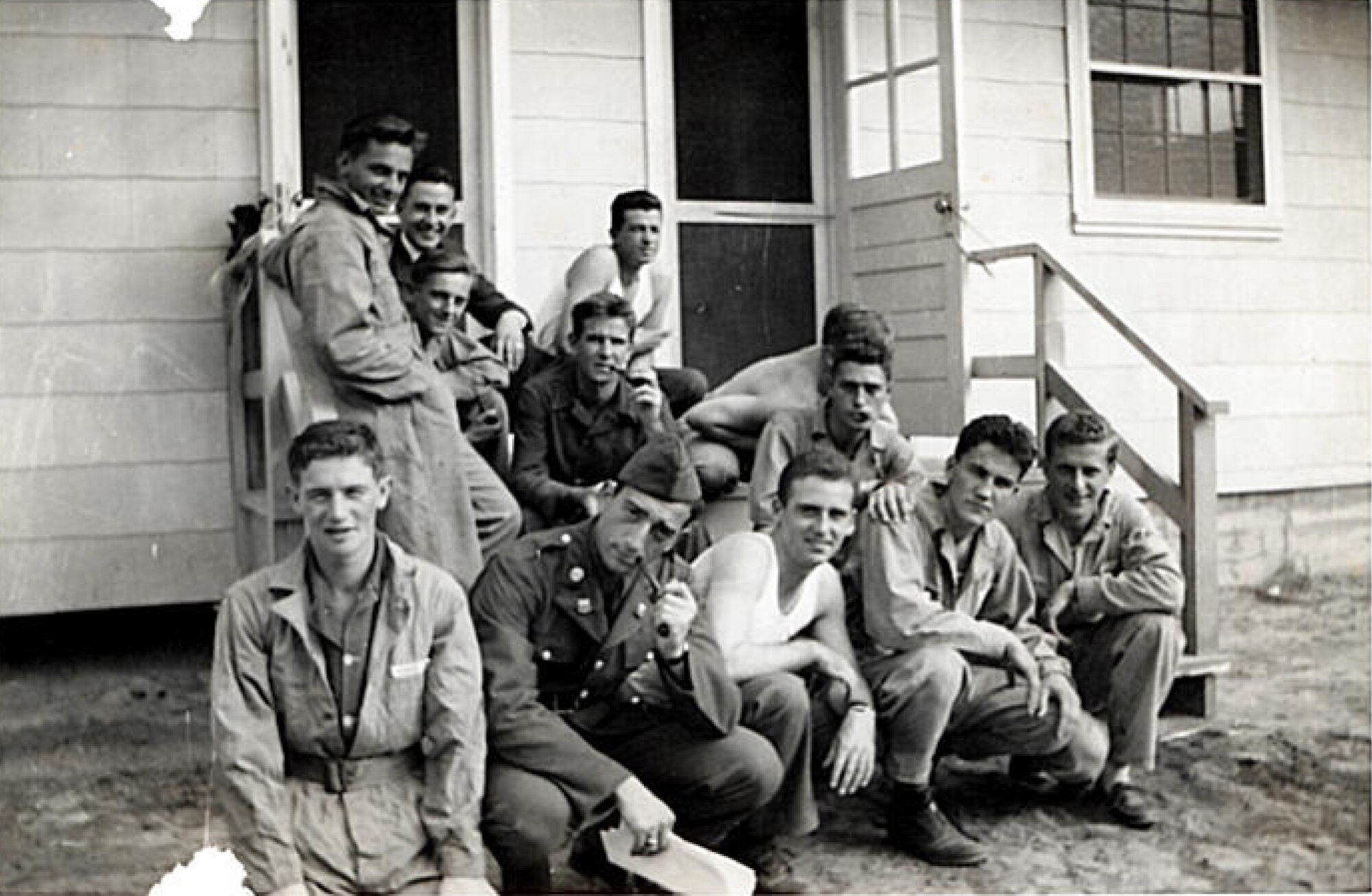 Aircraft mechanic students relax outside one of the dormitories in 1941, at Keesler Field, now known as Keesler Air Force Base, Miss. The dormitory was located south of where the present-day service station and shoppette are located.  Ninety-year-old Thomas Adams Jr., a member of the first class of aircraft mechanic students at Keesler in 1941, made a visit to the base Dec. 7, 2011, on the 70th anniversary of the Japanese attack on Pearl Harbor.  Adams has made his home in Pass Christian, Miss., since 1966 when he retired with 25 years of service in the Army Air Corps which was later name Air Force.  (Courtesy photo)