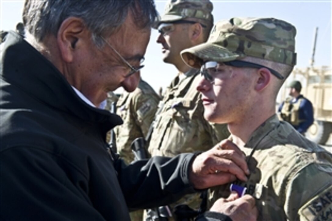 U.S. Defense Secretary Leon E. Panetta presents a Purple Heart to a soldier assigned to the 172nd Infantry Brigade on Forward Operating Base Sharana in Afghanistan, Dec. 14, 2011. Panetta awarded 12 Purple Hearts to soldiers during his visit. 