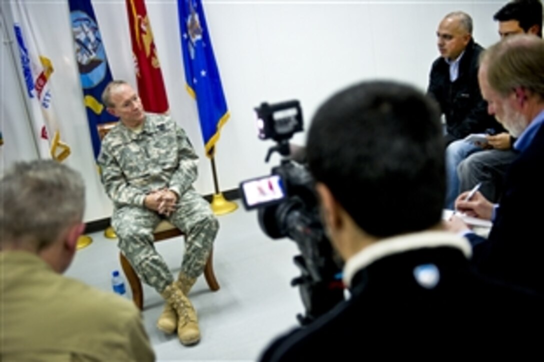 U.S. Army Gen. Martin E. Dempsey, chairman of the Joint Chiefs of Staff, takes questions from members of the press on Camp Buehring, Kuwait, Dec. 14,  2011.