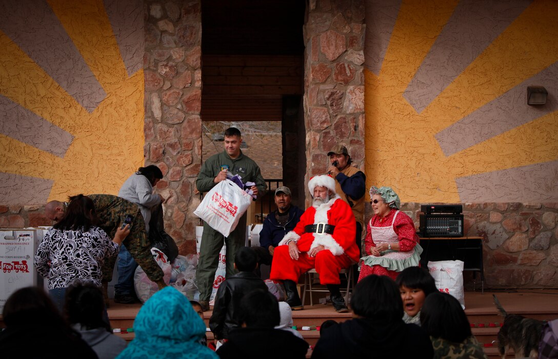 GRAND CANYON, Ariz. (Dec. 14, 2011) - U.S. Marine Corps Sgt. Christopher Morris, air-frames mechanic, Medium Helicopter Squadron 764 (HMM-764), 4th Marine Aircraft Wing, helps hand out toys to children of the Havasupai tribe. HMM-764's mission was to join the Flagstaff Community Toys For Tots Organization in delivering Santa Claus and toys to the children of the tribe, as well as conduct training exercises throughout the Grand Canyon as part of Operation Havasupai. Photo by Sgt. Alvin D. Parson
