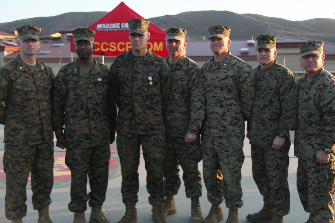 Lance Cpl. Cody Goebel, 2nd Battalion, 5th Marine Regiment, poses with Maj. Gen. Ronald Bailey, commanding general, 1st Marine Division, and other members of his higher command after his Silver Star award ceremony, Dec. 14, 2011. Goebel was awarded the Silver Star for actions while he was in Afghanistan with 3rd Battalion, 5th Marine Regiment.  Goebel was shot in the neck while on post in Helmand Province, Afghanistan. Ignoring his wound, he returned fire and refused medical attention until he was properly relieved.