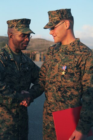 Major General Ronald Bailey, commanding general with 1st Marine Division, congratulates Lance Cpl. Cody Goebel, a team leader with 2nd Battalion, 5th Marine Regiment after Goebel’s Silver Star award ceremony. While serving with 3rd Battalion, 5th Marine Regiment, in Afghanistan, Goebel was hit in the neck by enemy fire. He knew his post was vital to his squad’s defense and returned fire before seeking medical aid.