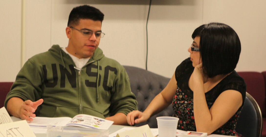 Brook Garcia and her husband, Lance Cpl. David Garcia, an electrician with 2nd Marine Logistics Group, talk during Marine Corps Community Service’s Marine Corps Family Team Building Marriage Enrichment Workshop at Midway Park a Marine Corps Base Camp Lejeune housing area Dec. 16. Brook and David feel people procrastinate and let their insecurities get in the way of bettering their marriage.