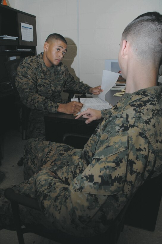 Lance Cpl. Cameron Perry, administrative specialist with Marine Corps Logistics Base Albany, combs through a Marine’s service record book updating his personal information, inside Military Personnel Center, recently.