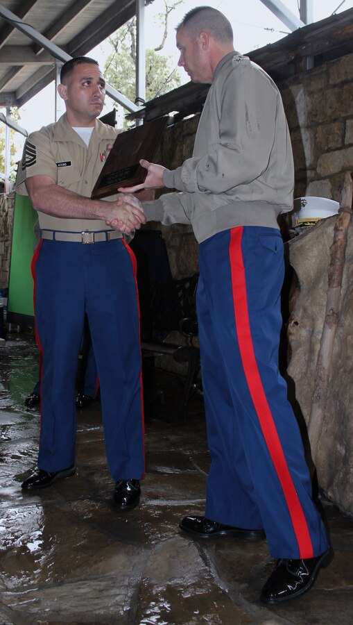 Col. Ted Studdard, commanding officer of the 8th Marine Corps District, presents Gunnery Sgt. Mario N. Atkins, staff noncommissioned officer-in-charge of Sector 1, Prior Service Recruiting Station 8, the Western Recruiting Region Staff NCOIC of the Year Award during a ceremony held at The Alamo in San Antonio, Texas, Dec. 15, 2011.  Atkins was named the best in the west for his superior management skills while leading the region in mission attainment.