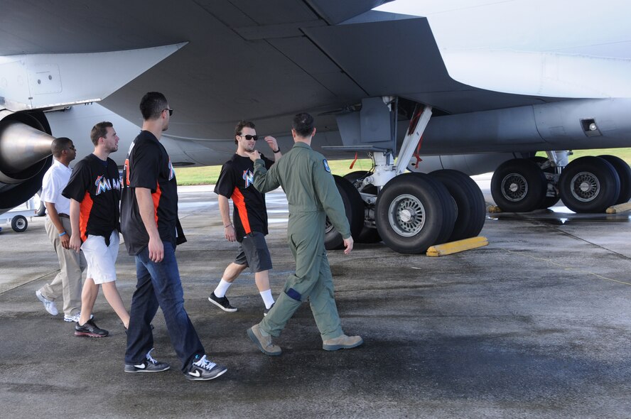 ANDERSEN AIR FORCE BASE, Guam- Team members of the Miami Marlins receive a tour from Senior Master Sgt. Dan Toskin, 121st Air Refueling Wing boom operator, during their visit to Team Andersen, Dec. 9. The tour is part of the Visit Our Troops 2011 and they also visited with troops in Hawaii and Japan. (U.S. Air Force photo/Senior Airman Carlin Leslie)