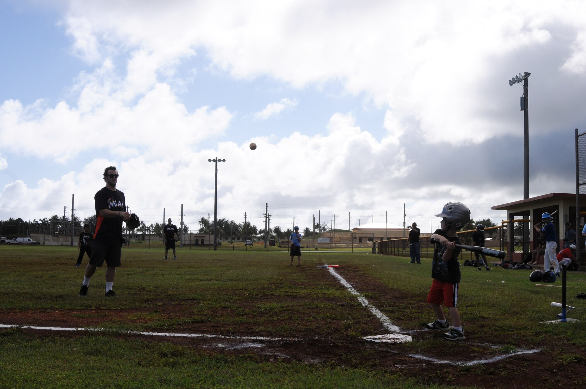 ANDERSEN AIR FORCE BASE, Guam- Bryan Peterson an outfielder from the Miami Marlins Major League Baseball Team, throws a pitch to Team Andersen youth, Dec. 9. The team held the clinic with more than 15 kids, playing a quick game. (U.S. Air Force photo/Senior Airman Carlin Leslie)