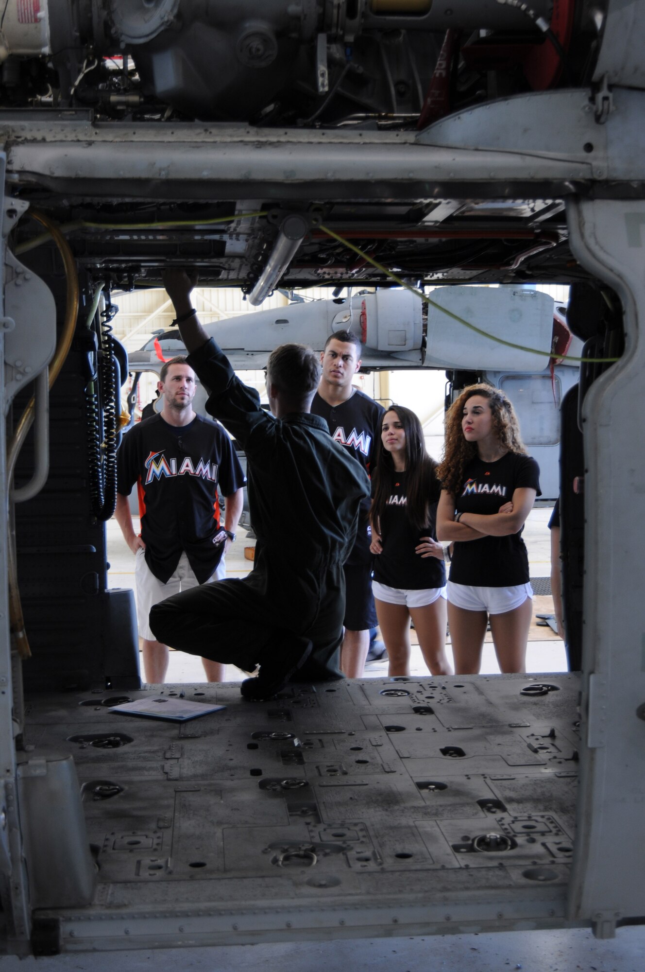 ANDERSEN AIR FORCE BASE, Guam- Team members from the Miami Marlins and Miami Mermaids receive a tour at Helicopter Sea Combat – 25 , Dec. 9. HSC-25 gave them an all exclusive look at the operations and missions they perform and let them see a bunch of equipment they use on a daily basis. (U.S. Air Force photo/Senior Airman Carlin Leslie)