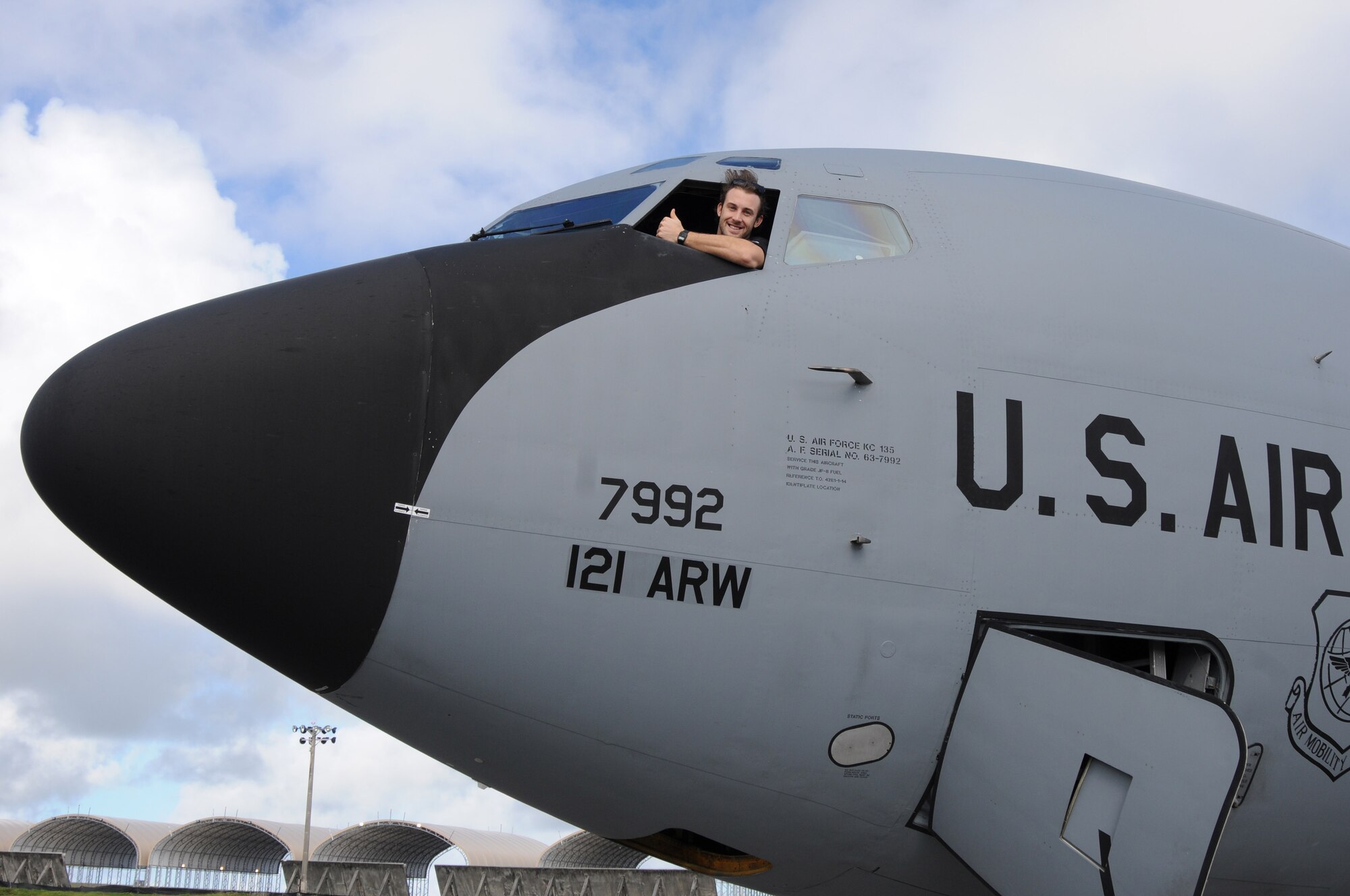 ANDERSEN AIR FORCE BASE, Guam- Bryan Peterson an outfielder from the Miami Marlins Major League Baseball Team, poses for a photo from the cockpit of a KC-135 Stratotanker from the 121st Air Refueling Wing, Dec. 9. The team visited Team Andersen to show their support for the troops and dependents. (U.S. Air Force photo/Senior Airman Carlin Leslie)