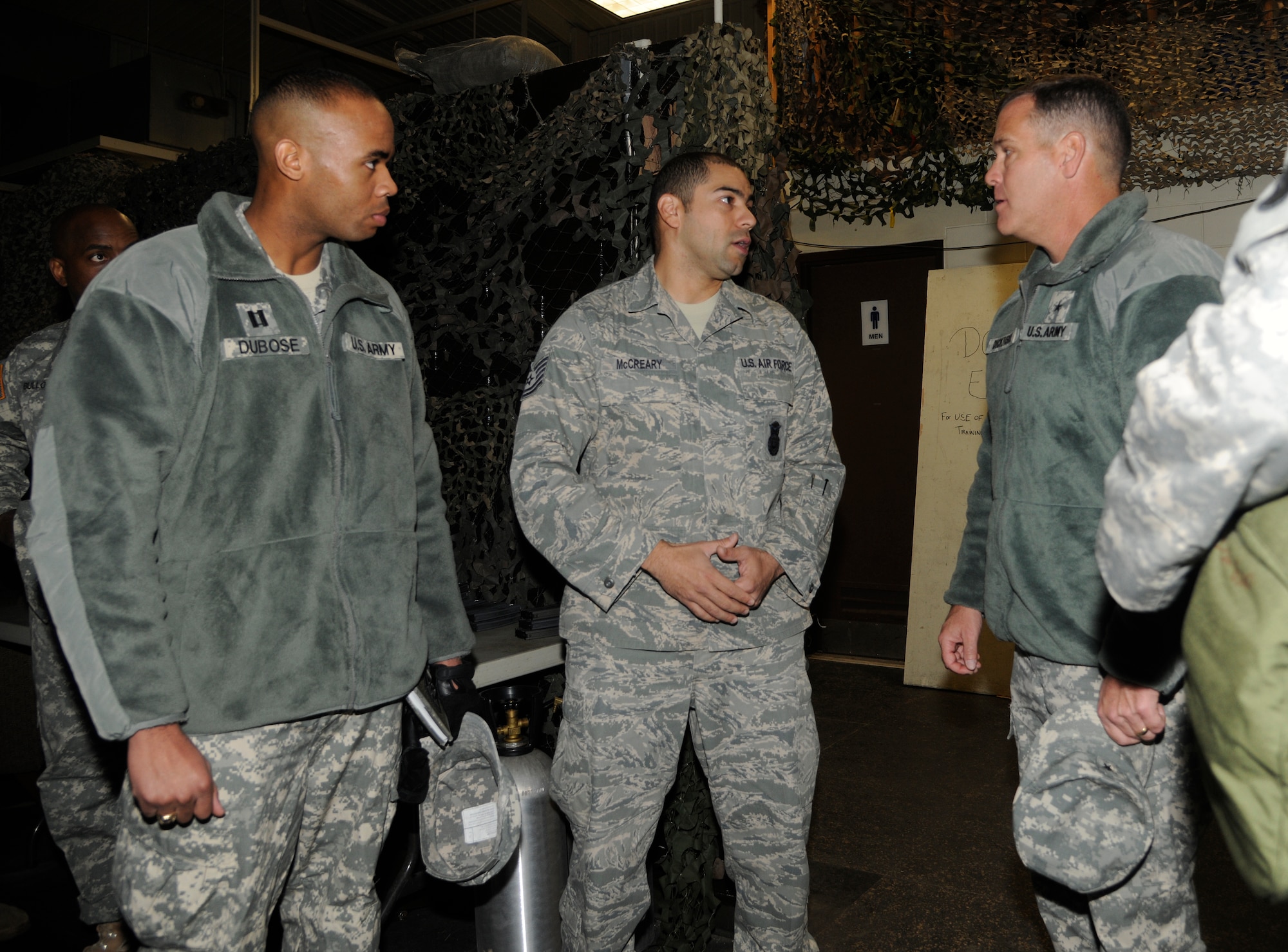 Tech. Sgt. Jeffrey McCreary, 8th Security Forces Squadron combat arms instructor, talks about the Engagement Skills Trainer program where Soldiers and security forces Airmen conduct weapon familiarization training at Kunsan Air Base, Republic of Korea, Dec. 8, 2011. Dickinson visited Soldiers and facilities of the Alpha Battery, 2nd Battalion of the 1st Air Defense Artillery during his tour of the Wolf Pack. (U.S. Air Force photo by Staff Sgt. Rasheen Douglas/Released)