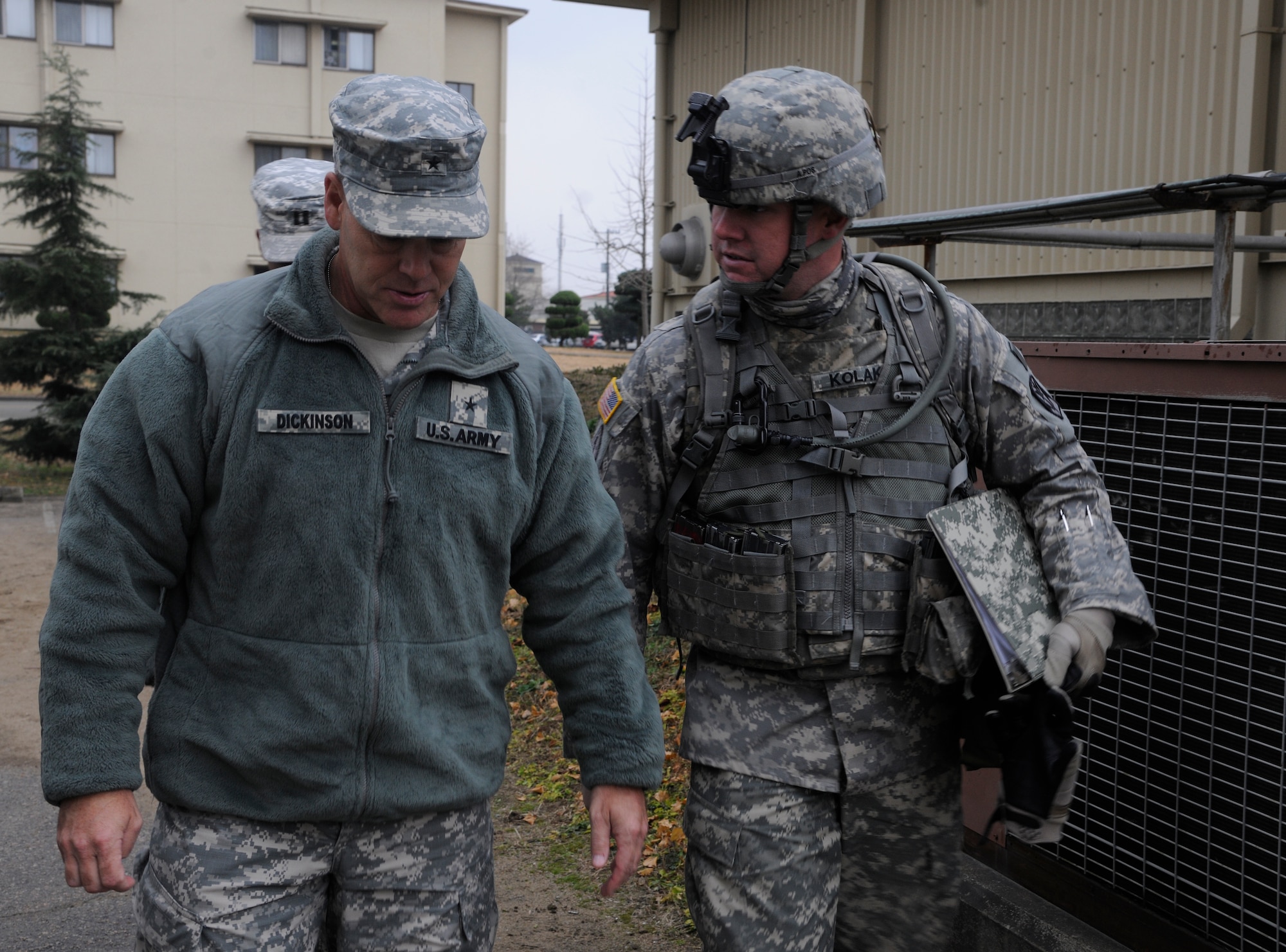 U.S. Army Brig. Gen. James Dickinson, 94th Army Air and Missile Defense commander, listens to U.S. Army Staff Sgt. Joshua Kolak, the unit’s support platoon sergeant, as he discusses training the Soldiers take part in with the Airmen from the Wolf Pack at Kunsan Air Base, Republic of Korea, Dec. 8, 2011.  Dickinson visited Soldiers and facilities of the Alpha Battery, 2nd Battalion of the 1st Air Defense Artillery during his tour of the Wolf Pack. (U.S. Air Force photo by Staff Sgt. Rasheen Douglas/Released)