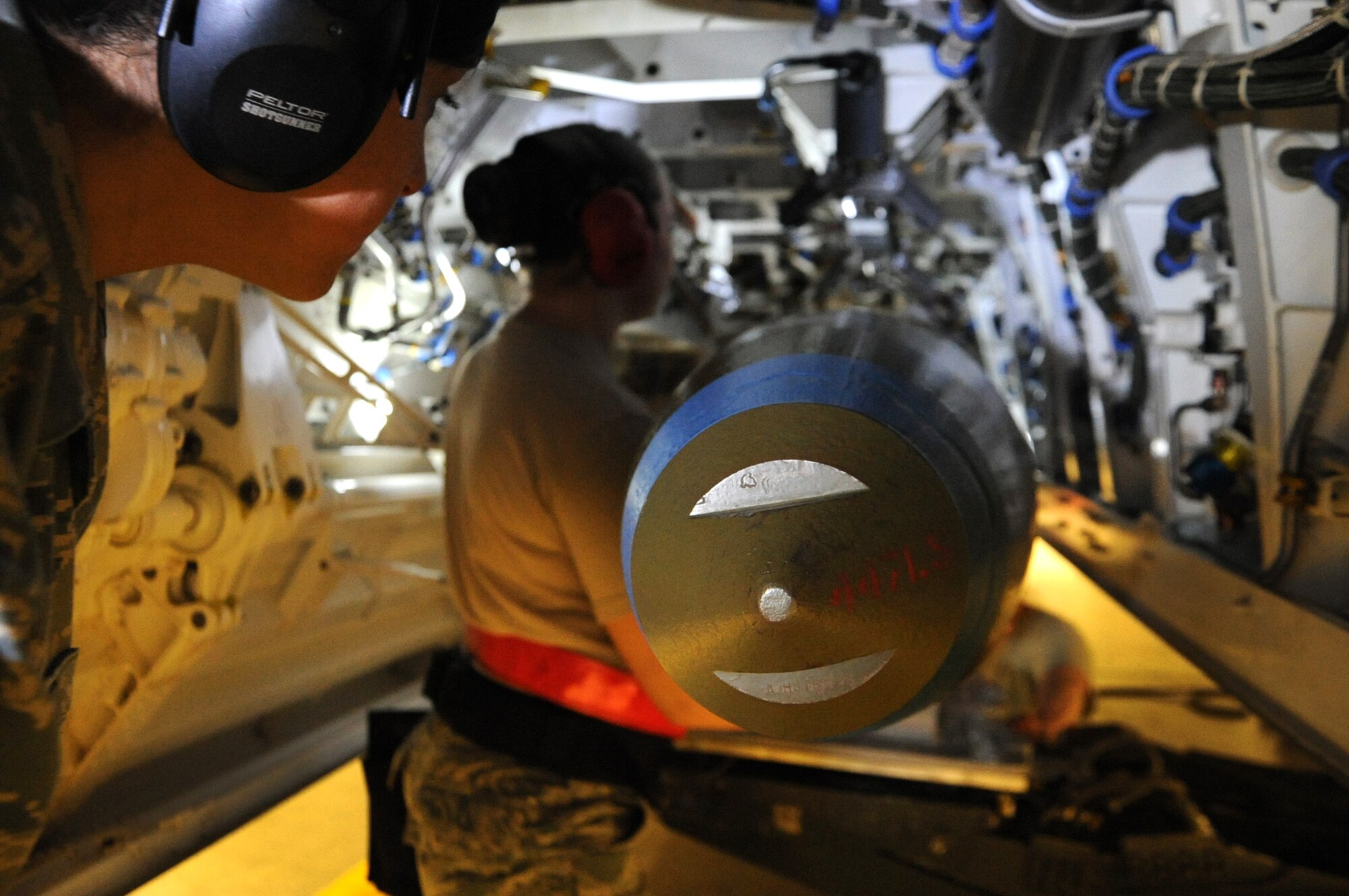 JOINT BASE ELMENDORF-RICHARDSON, Alaska -- A weapons load evaluater watches closely as members of the 90th Aircraft Maintenance Unit load a joint direct attack munition during a quarterly load competition Dec. 9. This crew went on to compete for the annual award Dec. 14. (U.S. Air Force photo/Staff Sgt. Cynthia Spalding) 
