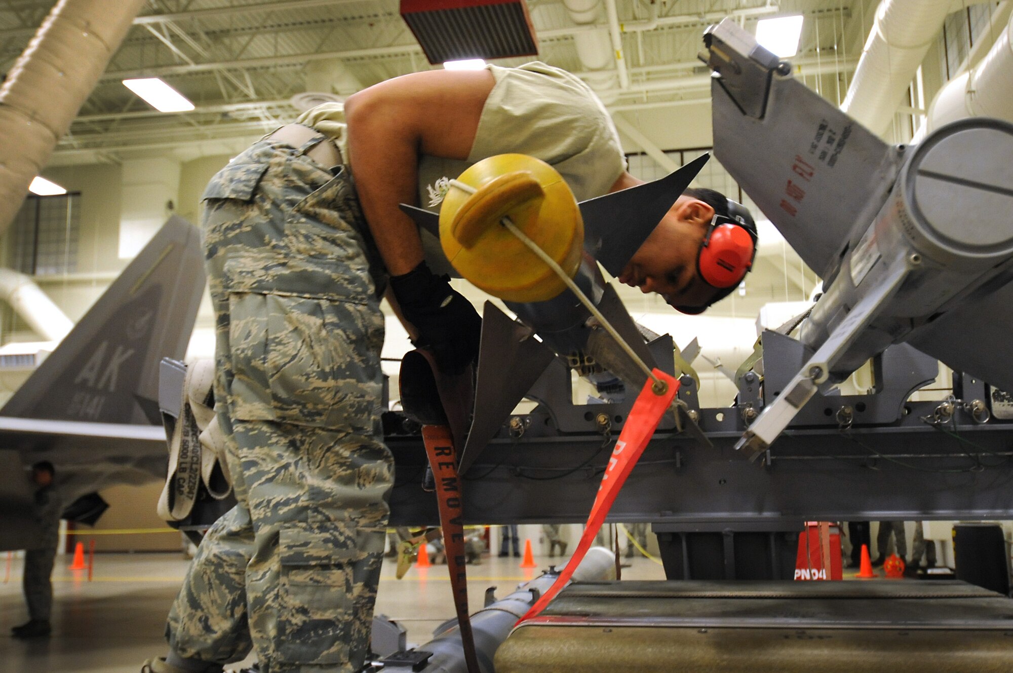 JOINT BASE ELMENDORF-RICHARDSON, Alaska -- Airman 1st Class Joshua Schmidt inspects an air intercept missile 9 during a quarterly weapons load competion Dec. 9. His crew went on to compete for the annual award Dec. 14. Schmidt is an aircraft armament systems specialist with the 90th Aircraft Maintenance Unit. (U.S. Air Force photo/Staff Sgt. Cynthia Spalding)