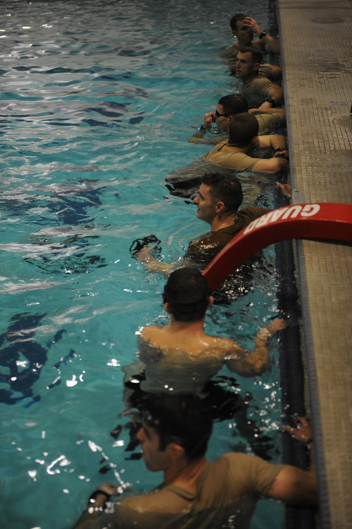 SERE candidates look to their instructor for explanation of their next training exercise at the aquatics center Dec. 6. (U.S. Air Force photo/Airman 1st Class Earlandez Young) 